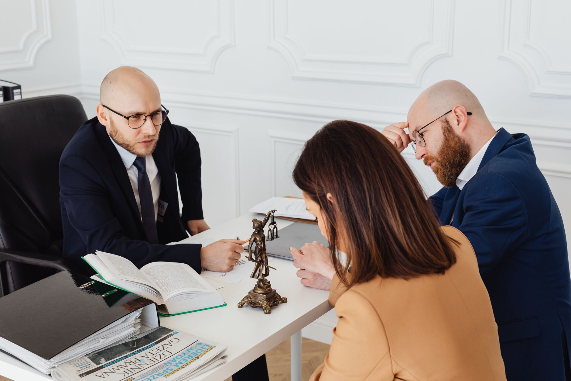 Professional real estate attorney reviewing property documents with client during home purchase consultation