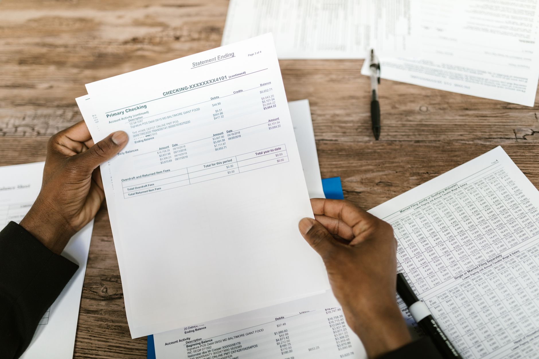 Professional accountant reviewing tax documents and financial papers at desk