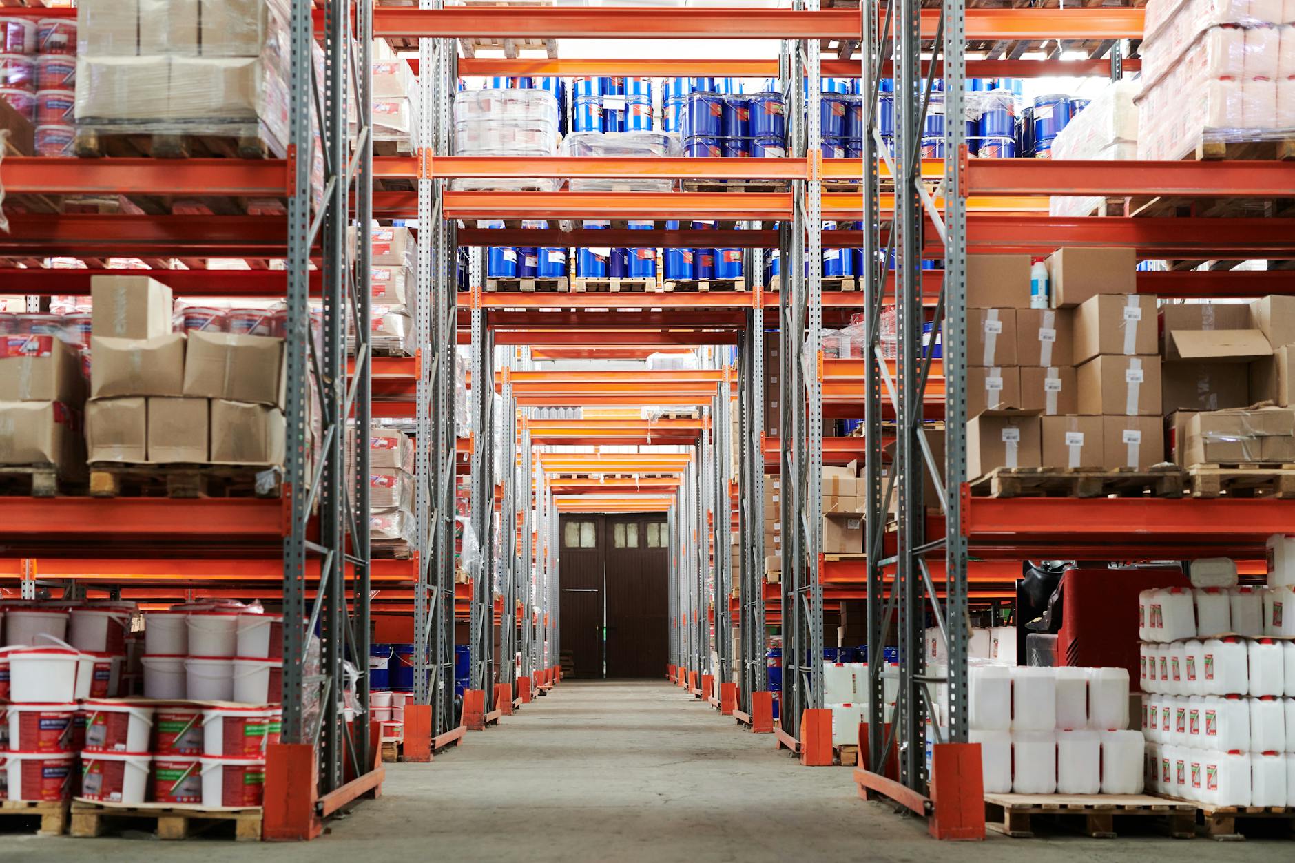 Rows of stacked pallets with liquidation inventory in a modern warehouse facility ready for bulk buyer distribution