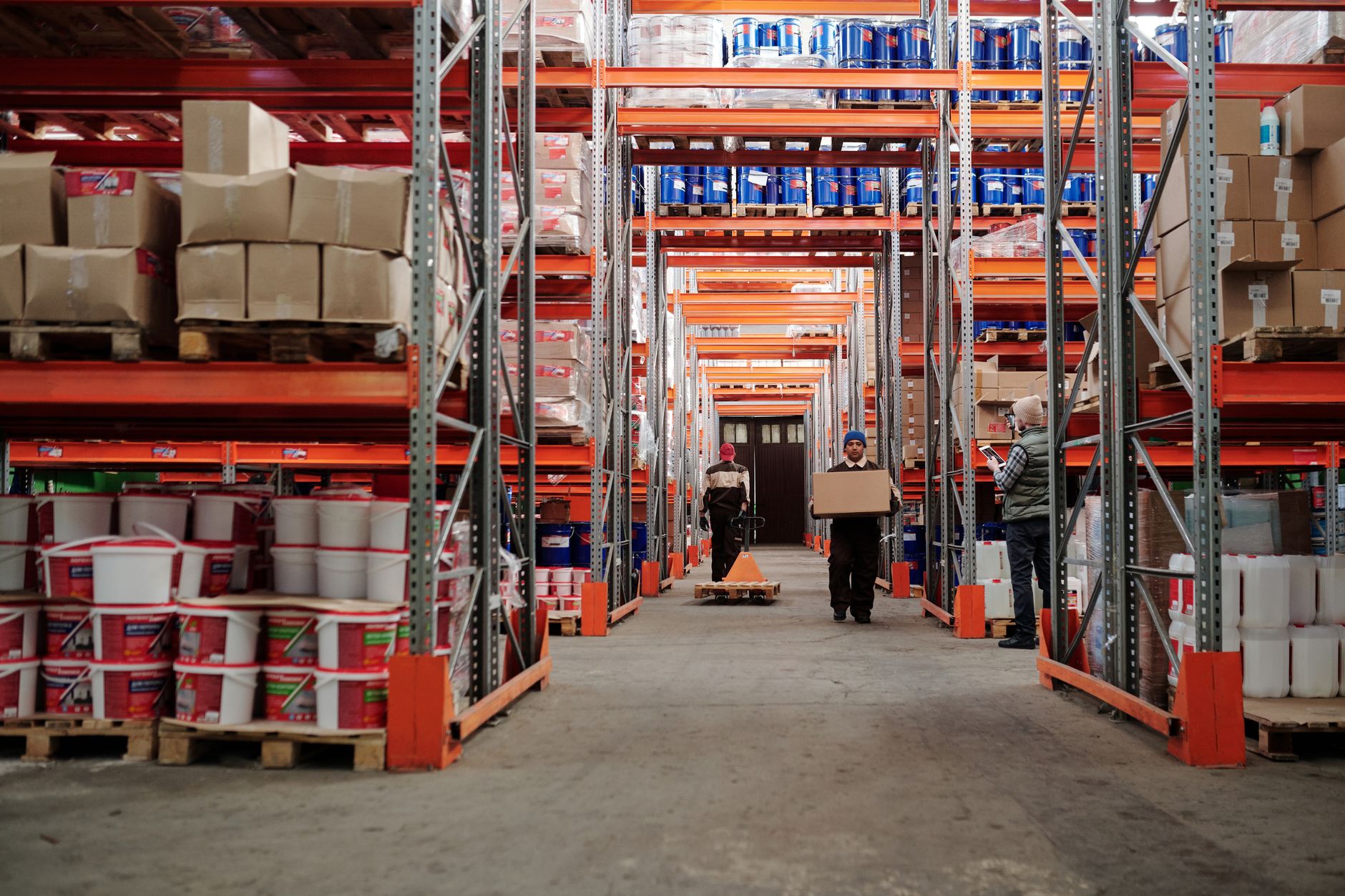 Warehouse workers processing and sorting returned e-commerce packages on conveyor system in modern fulfillment center