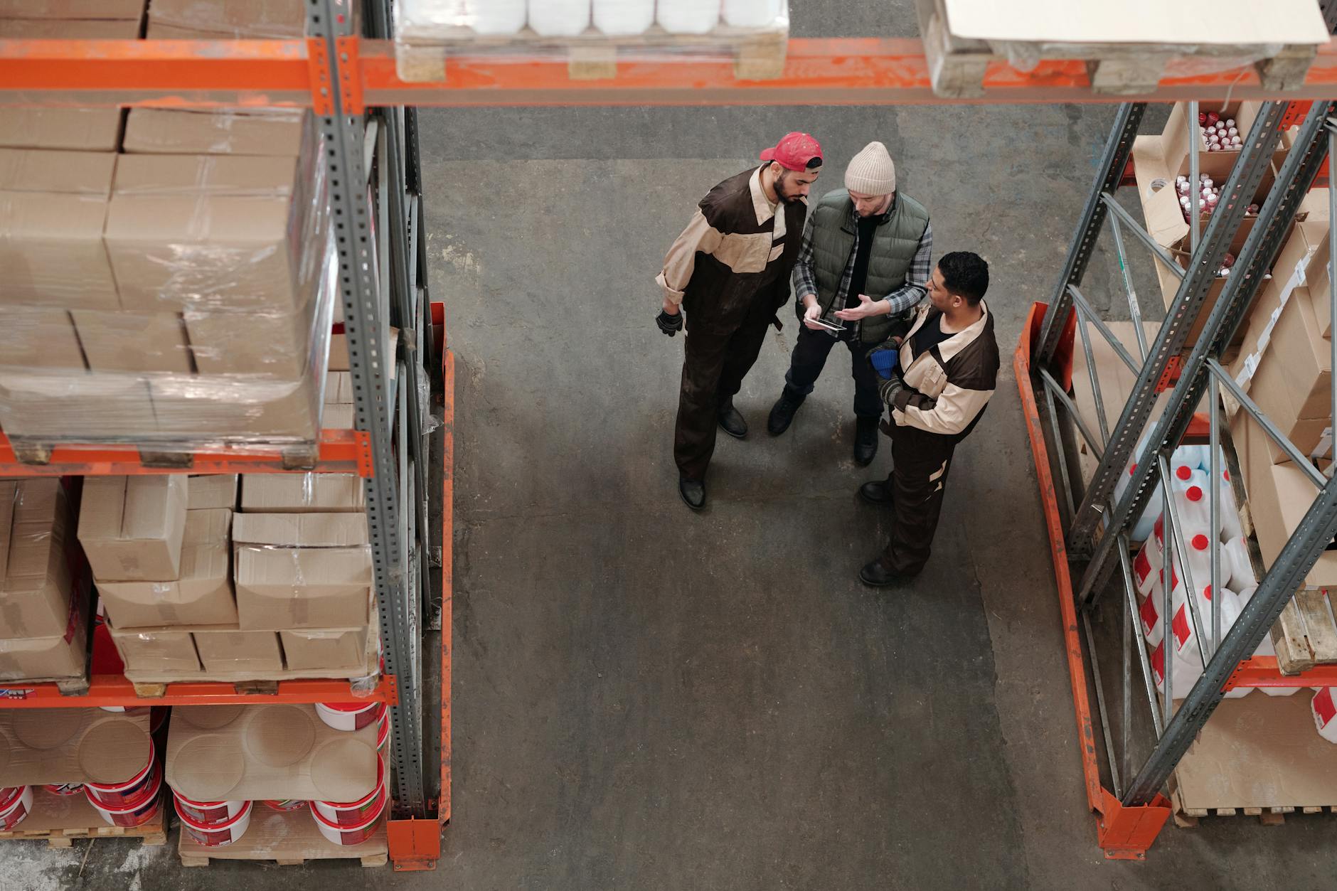 Wholesaler examining and pricing mixed liquidation pallets in warehouse setting