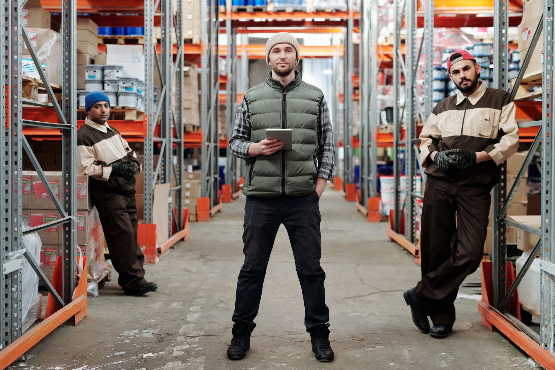 Warehouse workers using computers to manage inventory systems and logistics operations efficiently