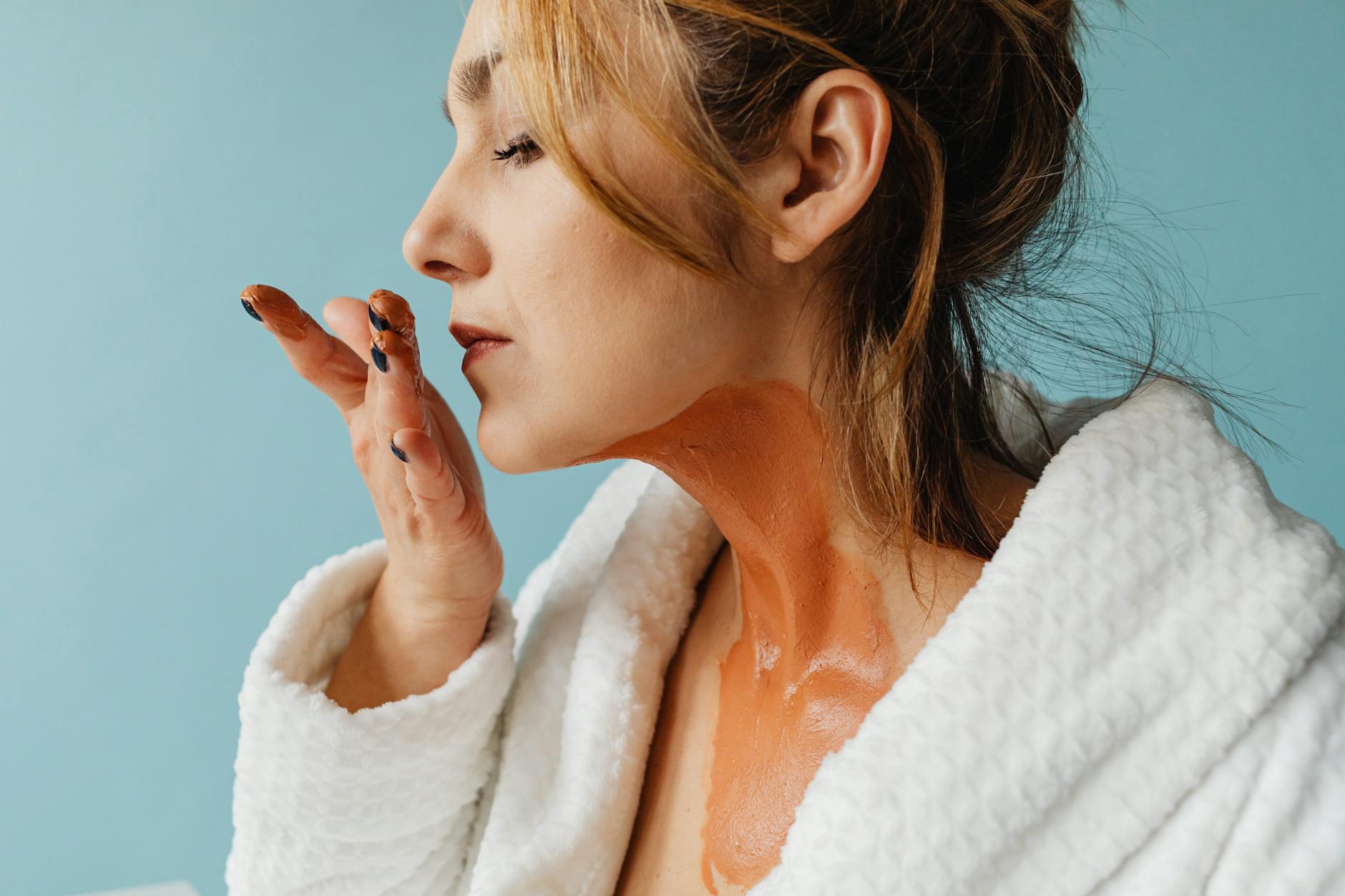 Woman applying natural skincare products as part of her clean beauty routine with minimal ingredients