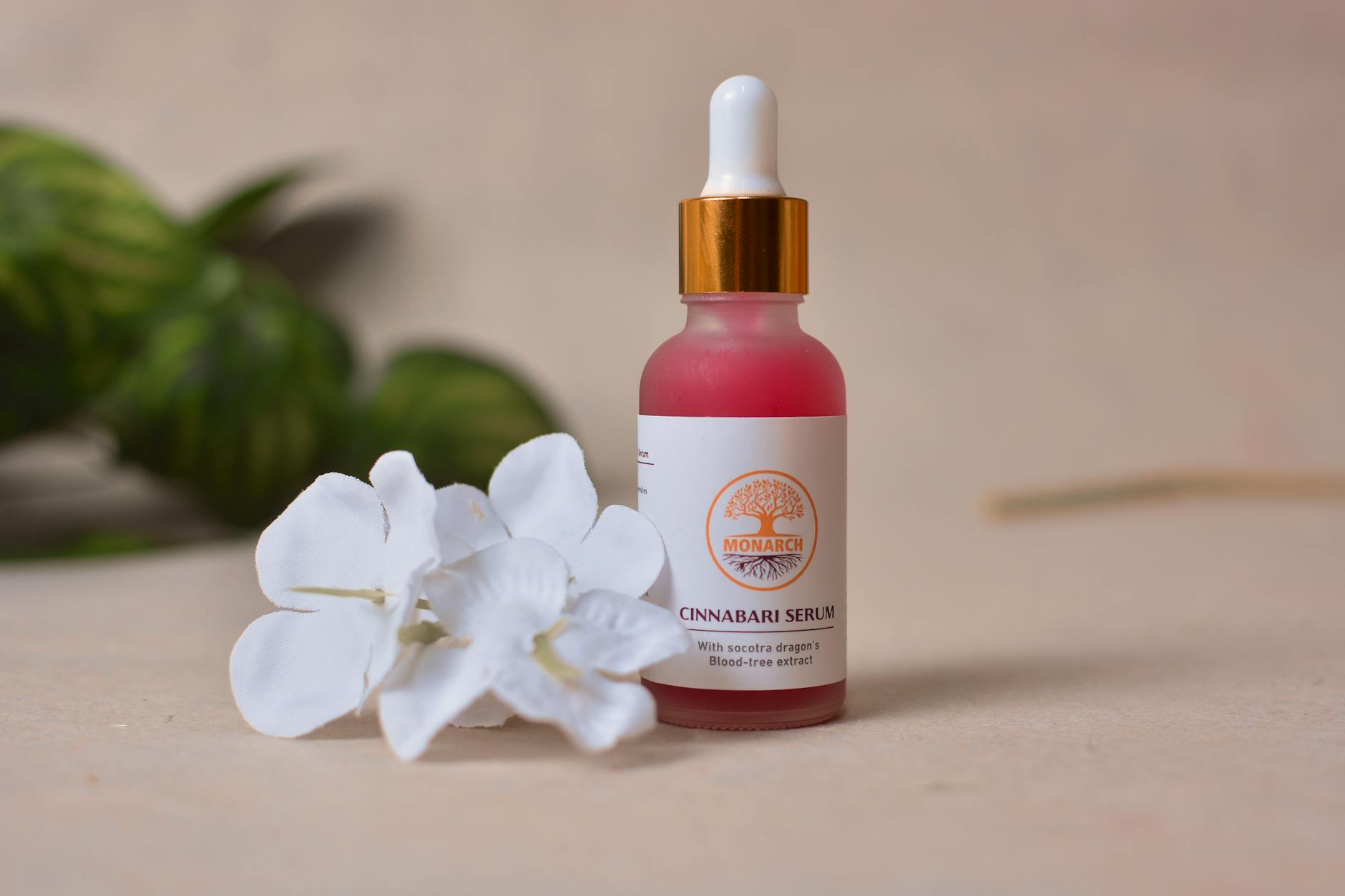 Close-up of vitamin C serum bottle with dropper on white background, clean beauty product photography