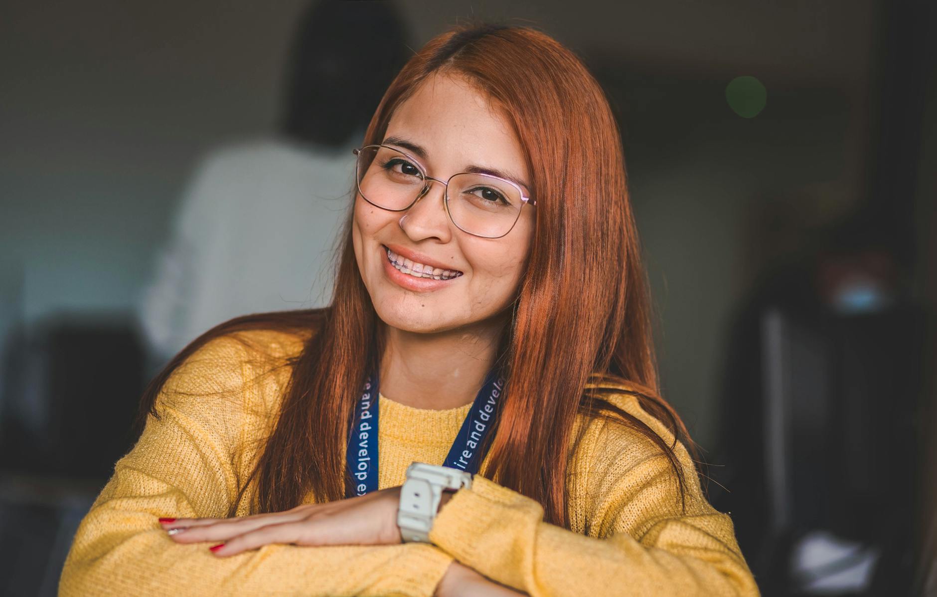 Adult woman displaying confident smile showing orthodontic braces treatment results