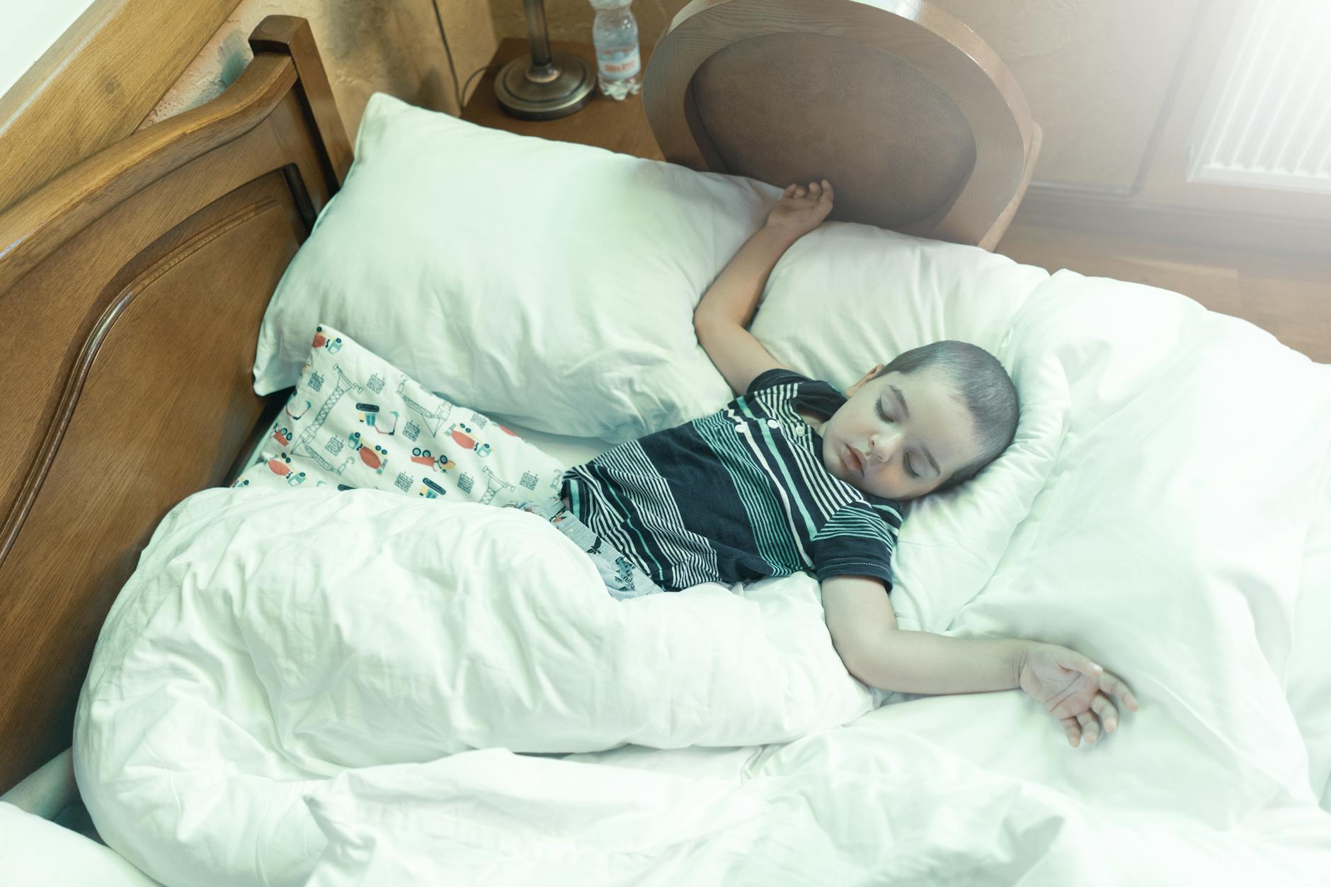 Young child sleeping soundly in bed, demonstrating improved breathing and rest quality from airway-focused orthodontic treatment