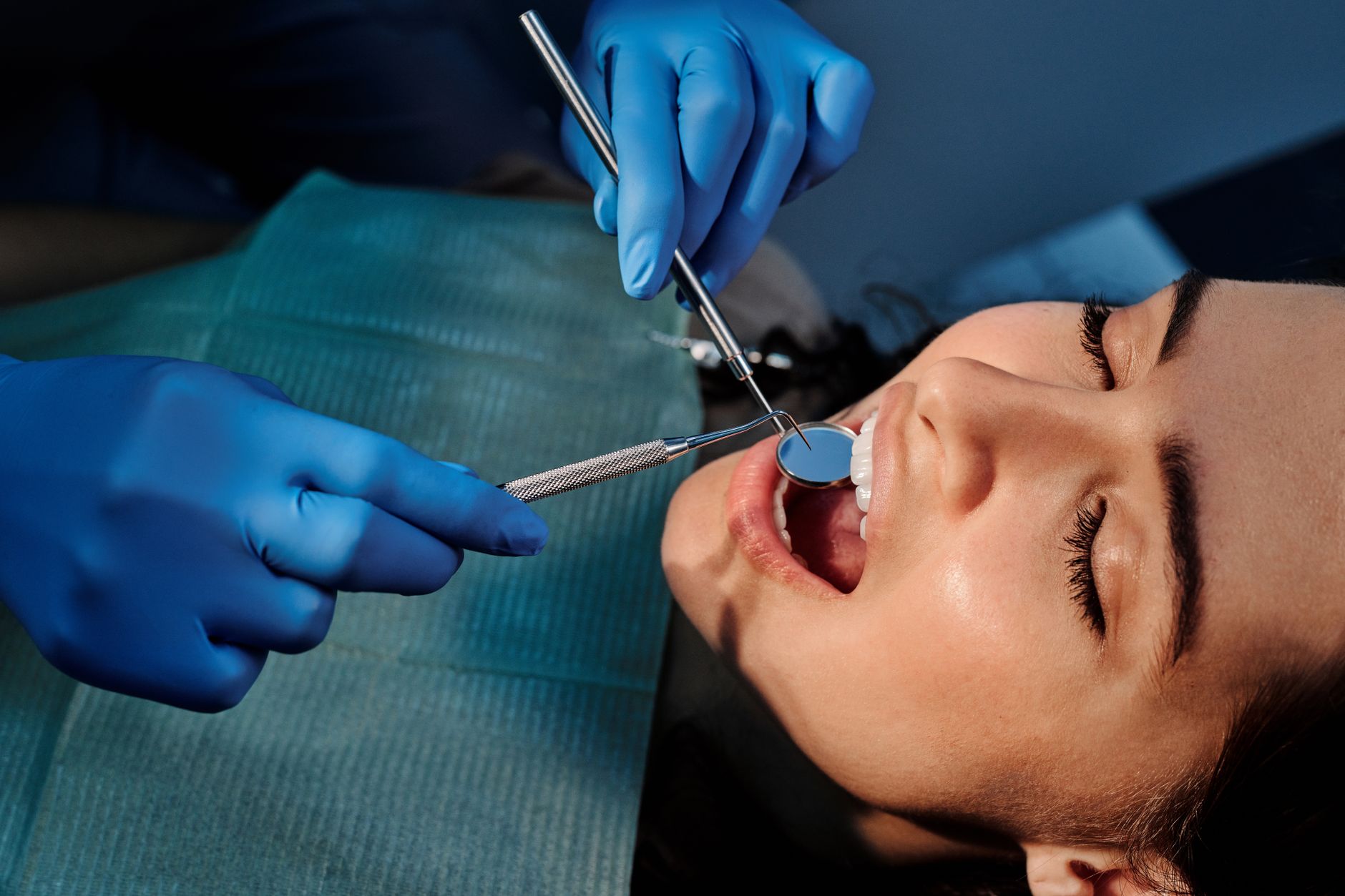 Board-certified orthodontist examining patient's teeth and bite alignment during consultation