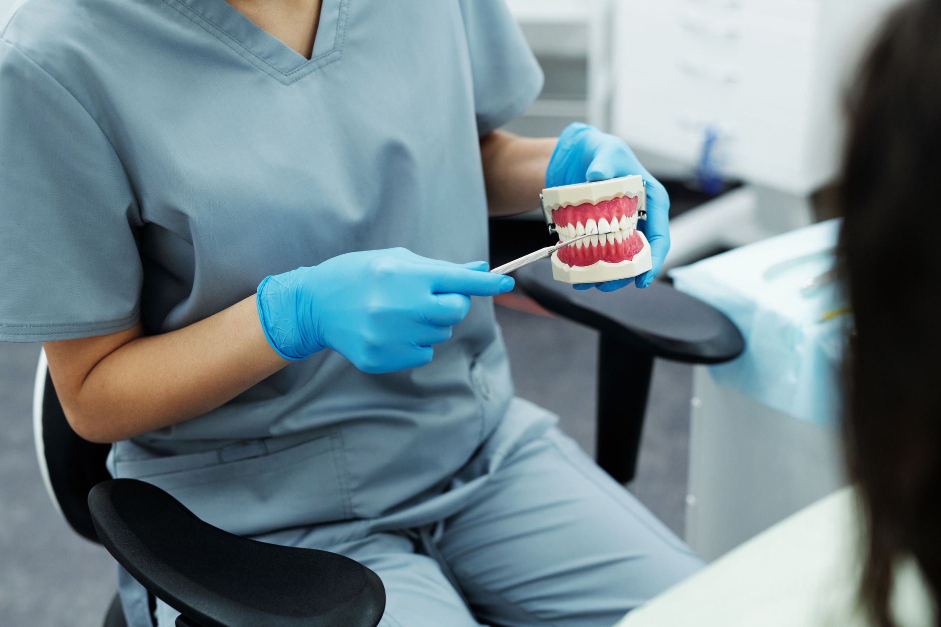 Orthodontist discussing treatment options and payment plans with patient in modern dental office