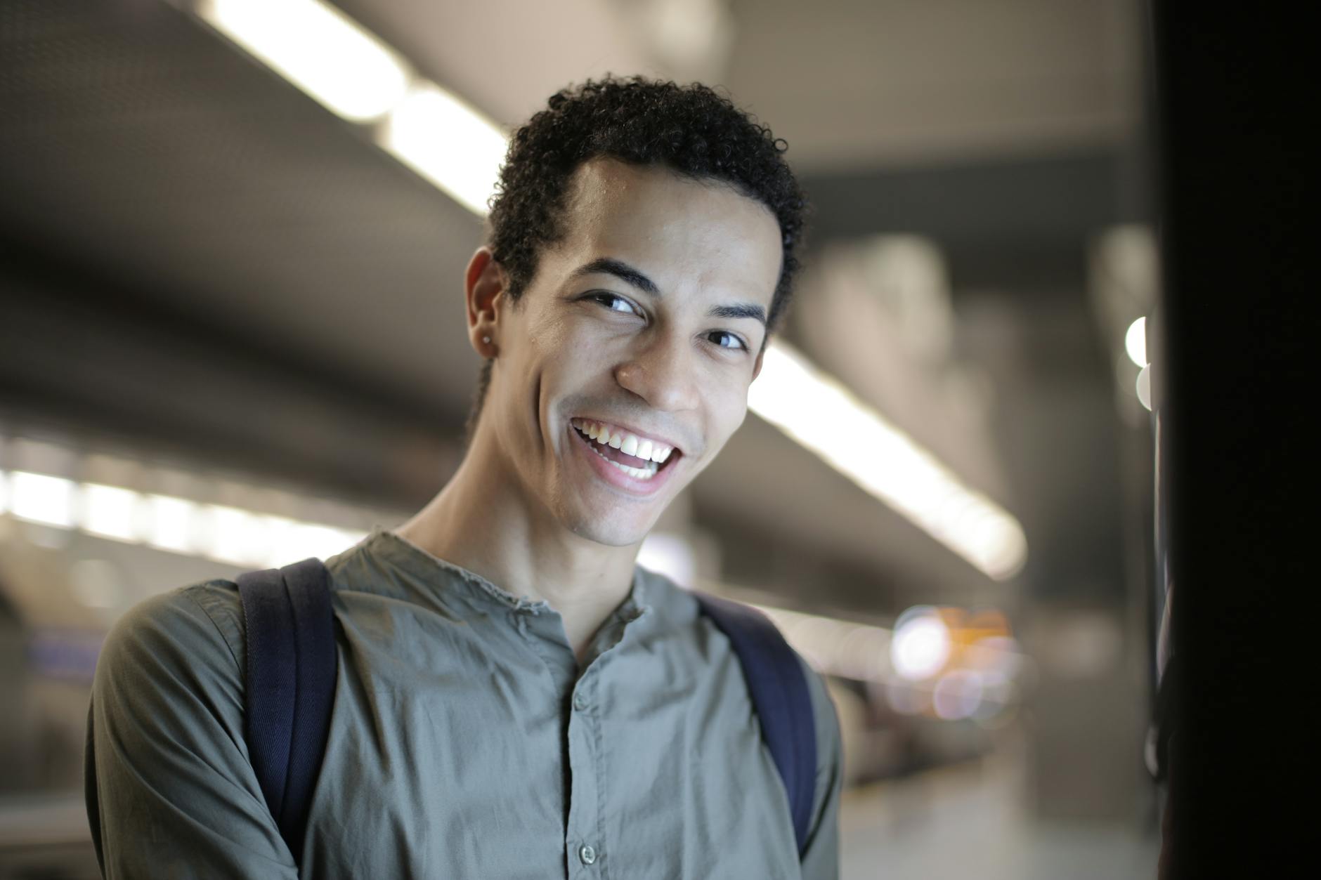 Adult patient displaying clear dental aligners with confident smile during orthodontic treatment