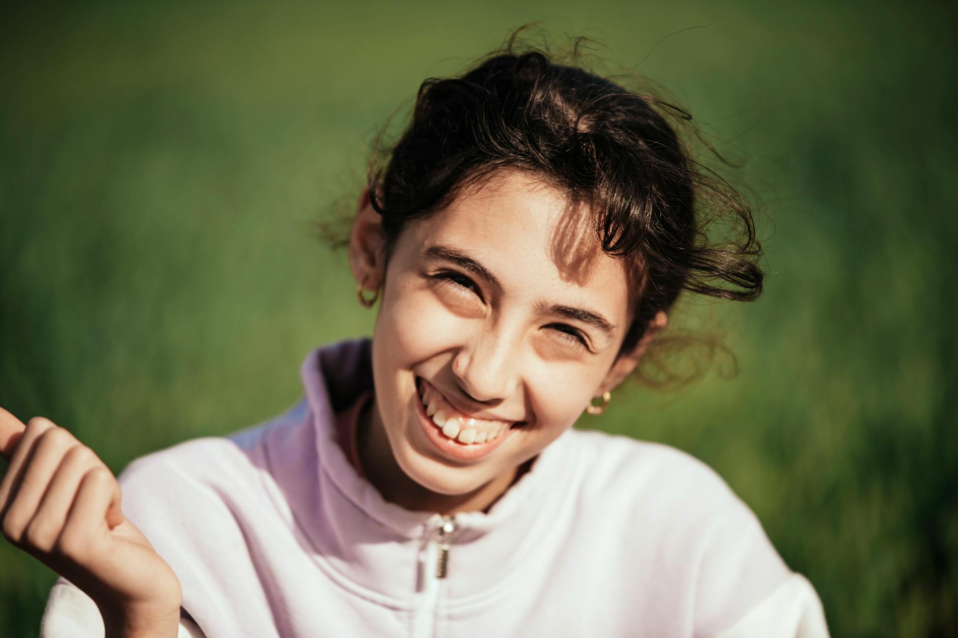 Teenage patient displaying orthodontic treatment results with a bright smile and confidence