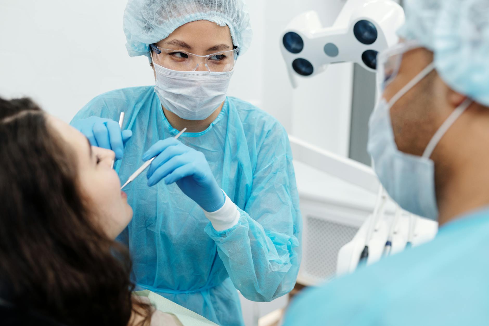 Orthodontist examining patient's teeth and bite during consultation appointment for braces treatment