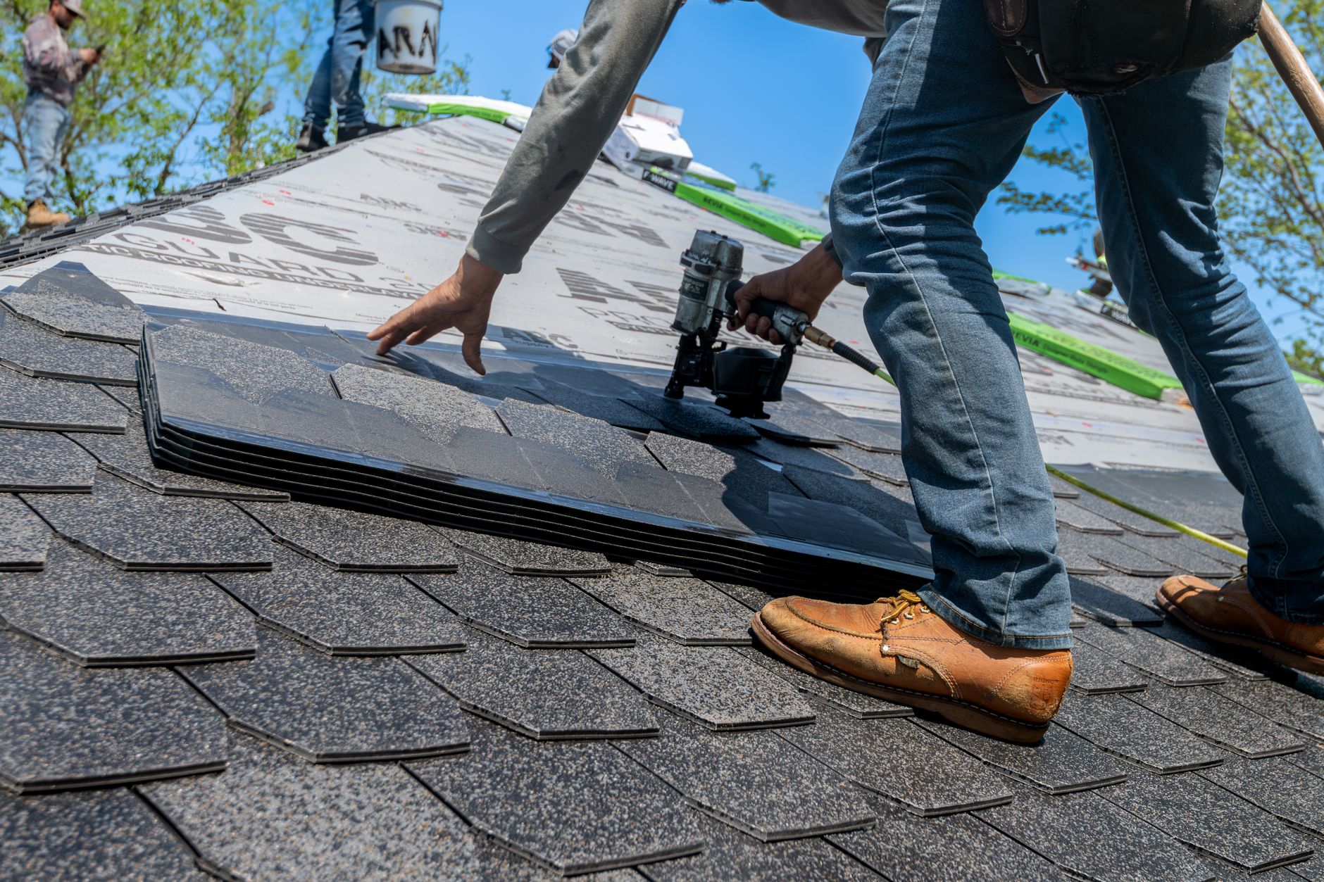 Commercial roofing contractor installing TPO or PVC membrane on flat roof