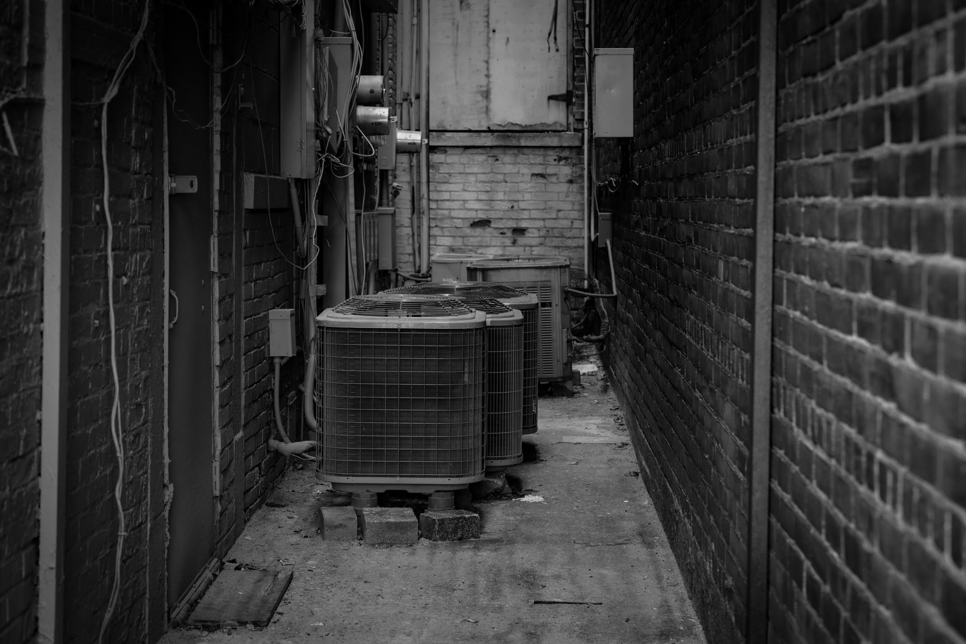 Professional HVAC technician inspecting and repairing an air conditioning outdoor unit