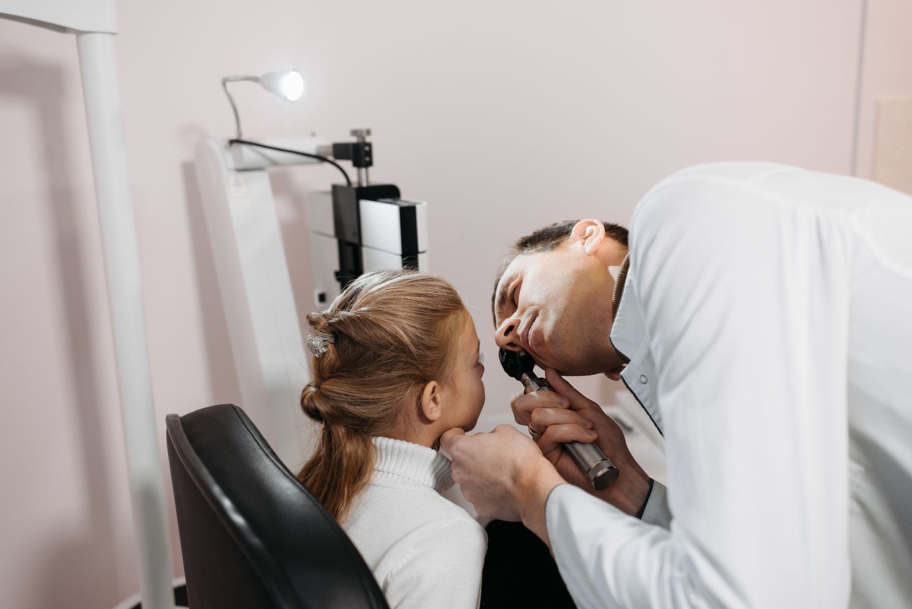 optometrist performing eye examination on patient in modern clinic setting