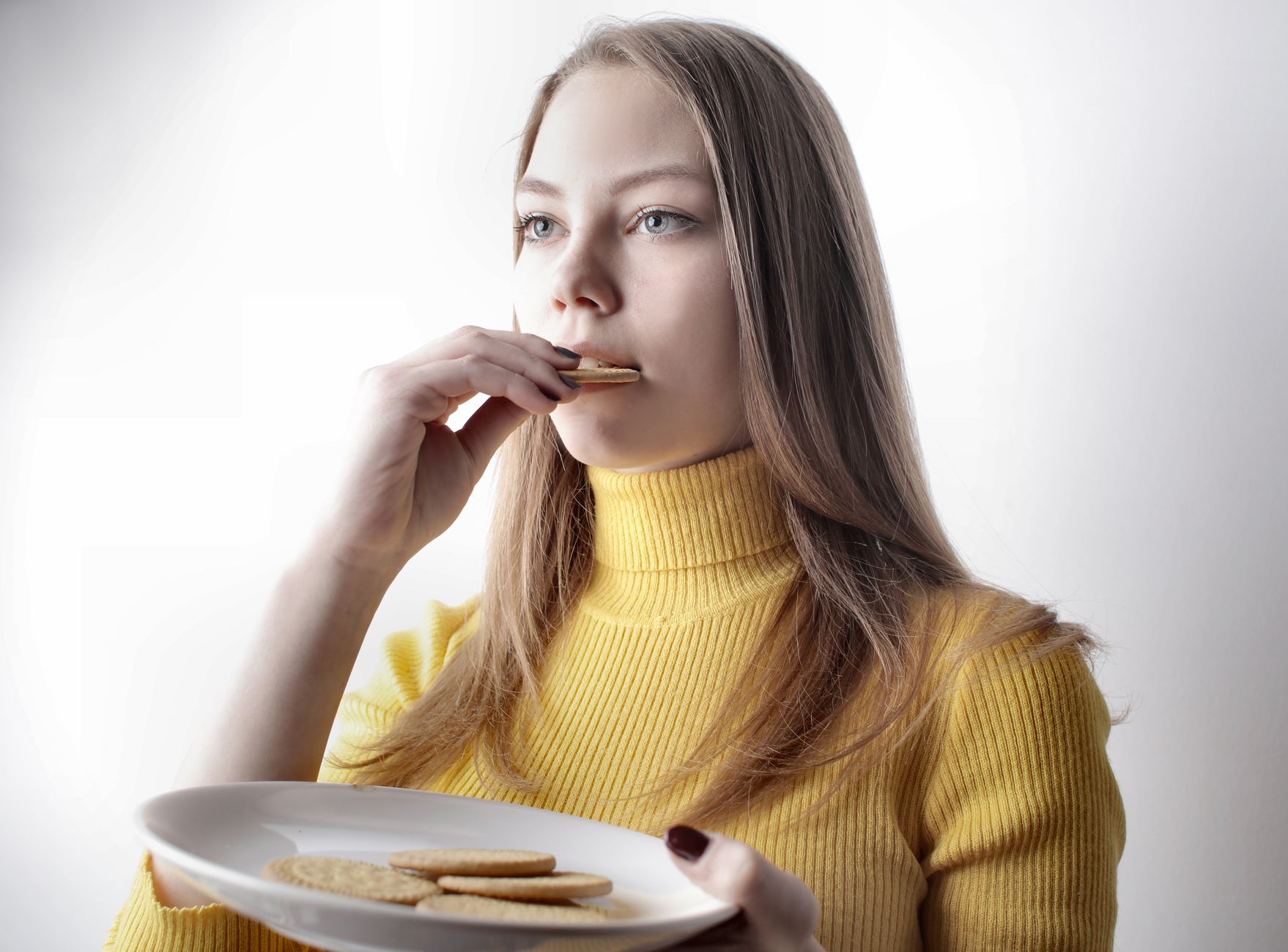 Woman mindfully enjoying a premium seaweed snack as part of her daily wellness routine