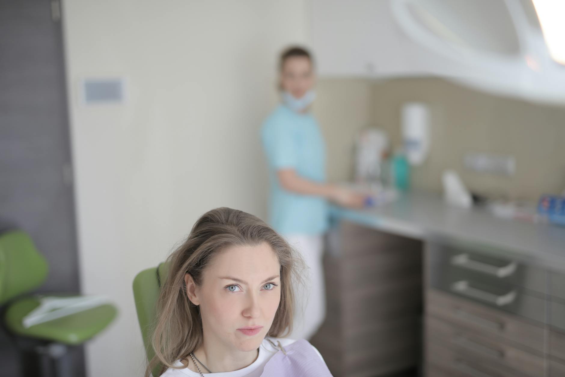 Woman experiencing dental pain with hand on cheek, indicating need for dental care