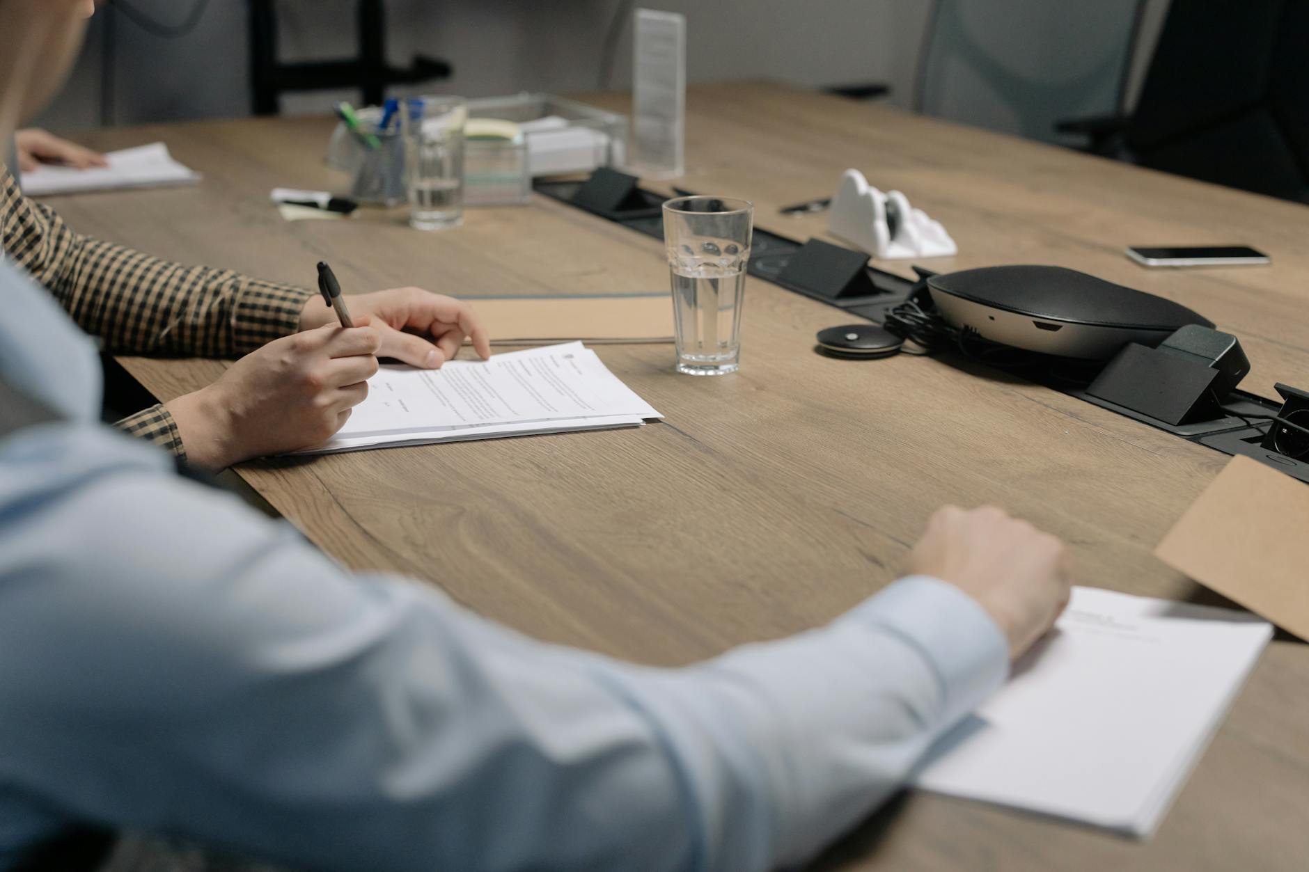 Patient reviewing dental financing paperwork with dentist before signing treatment agreement