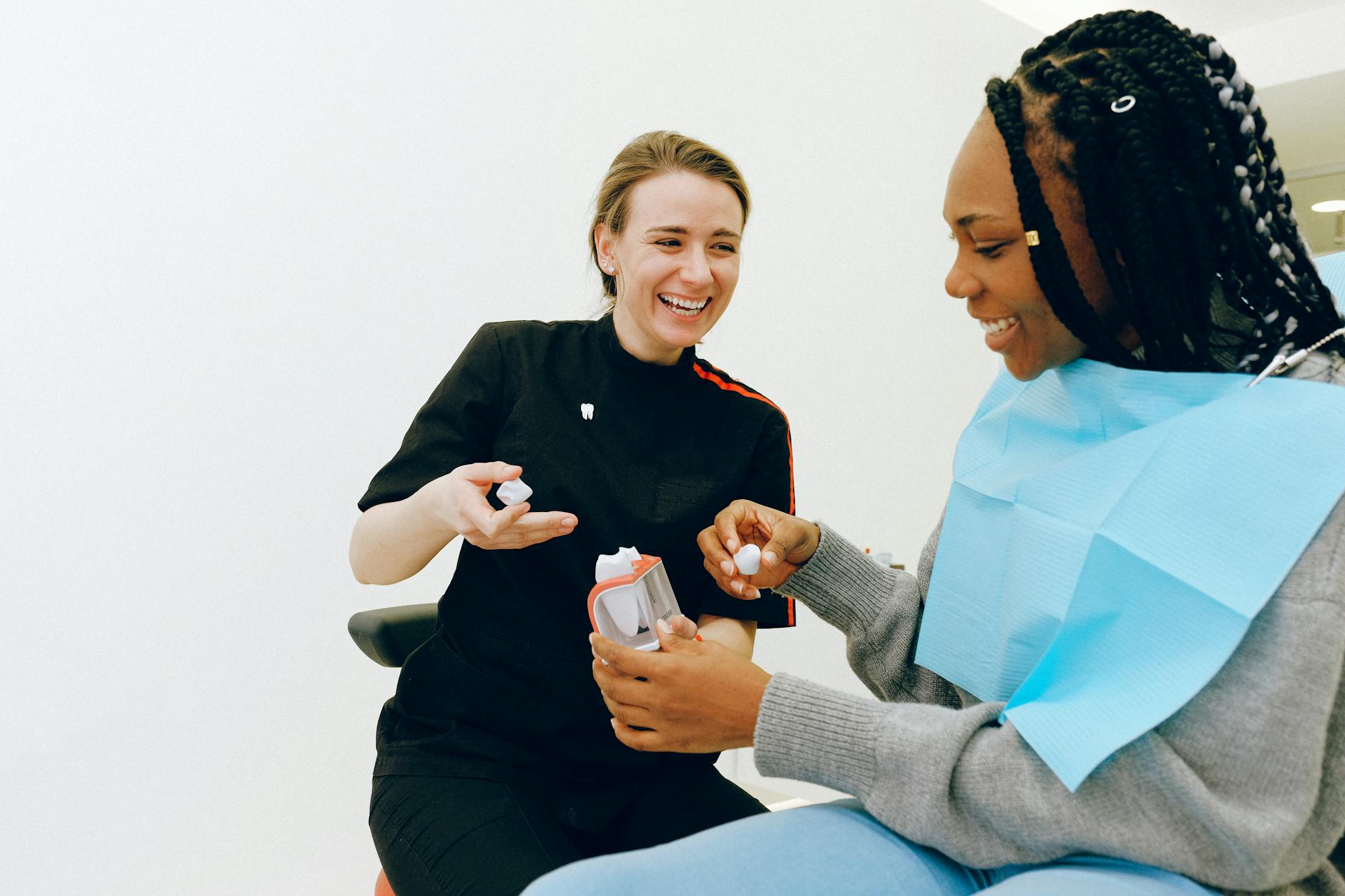 Adult patient comparing Invisalign clear aligners with traditional metal braces during orthodontic consultation