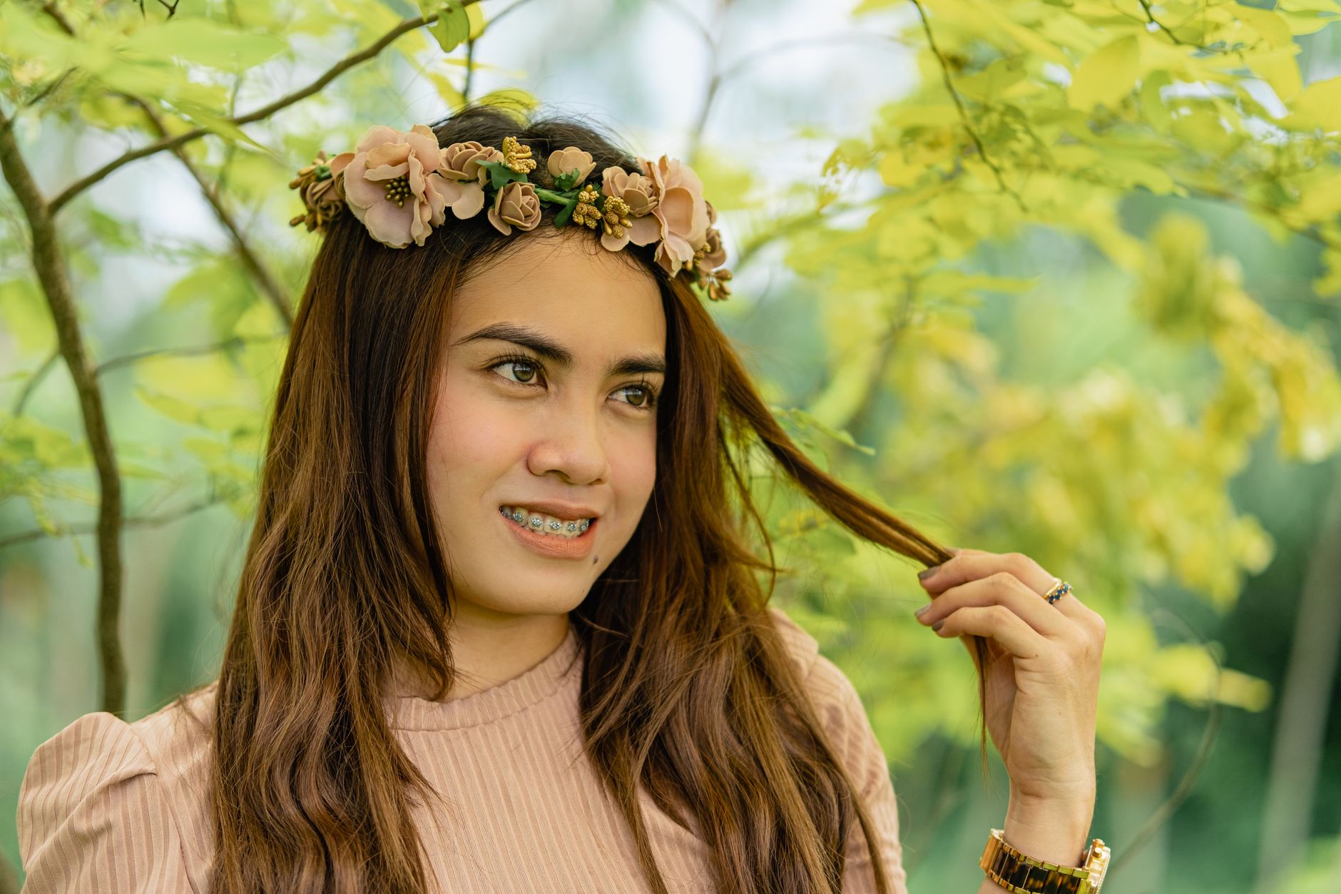 Young woman displaying healthy smile with clear dental braces, showing teeth alignment results