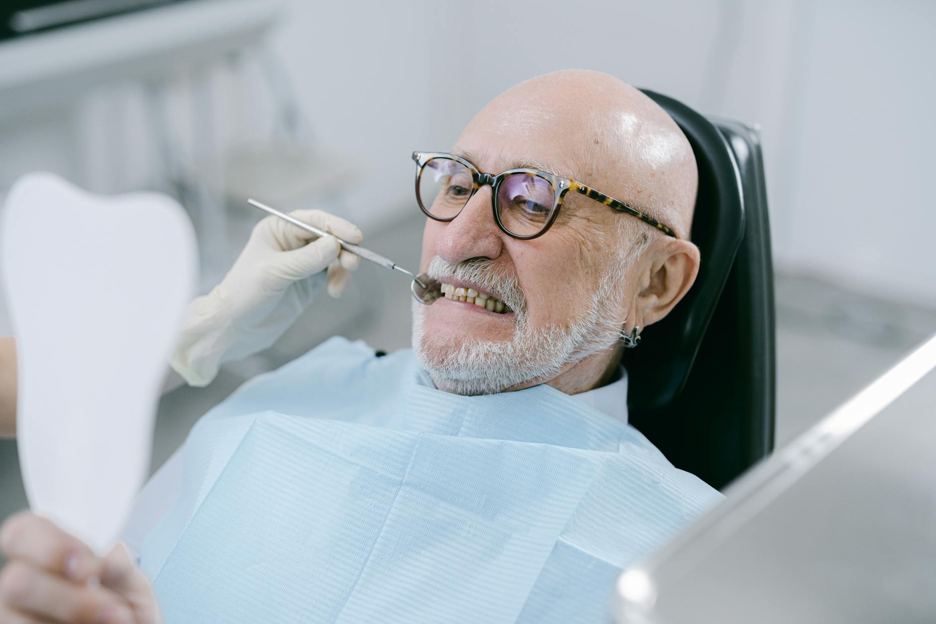 Close-up of patient displaying full dental implants and natural-looking smile after All-on-4 treatment