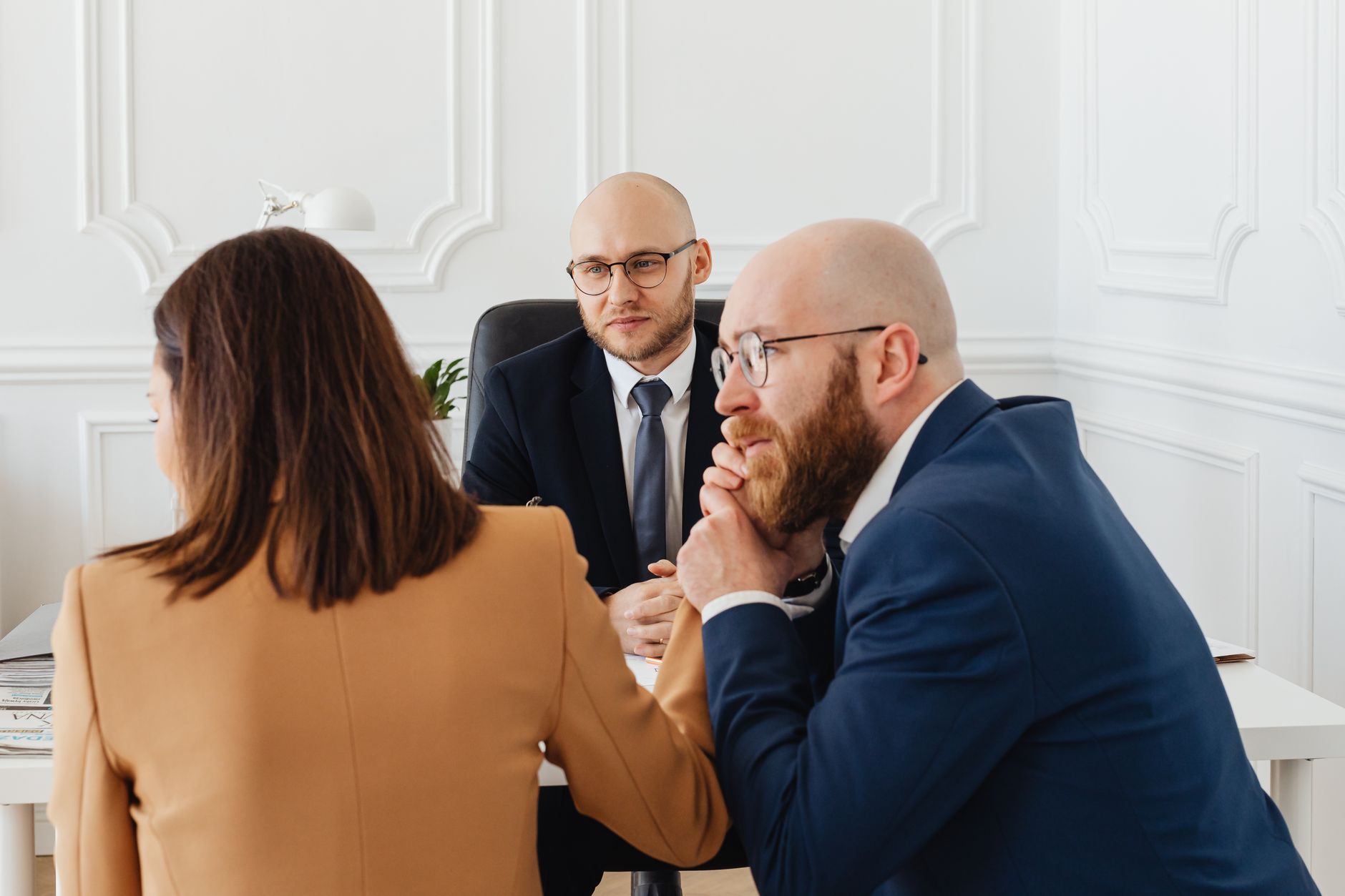 Personal injury attorney discussing case details with client during office consultation meeting