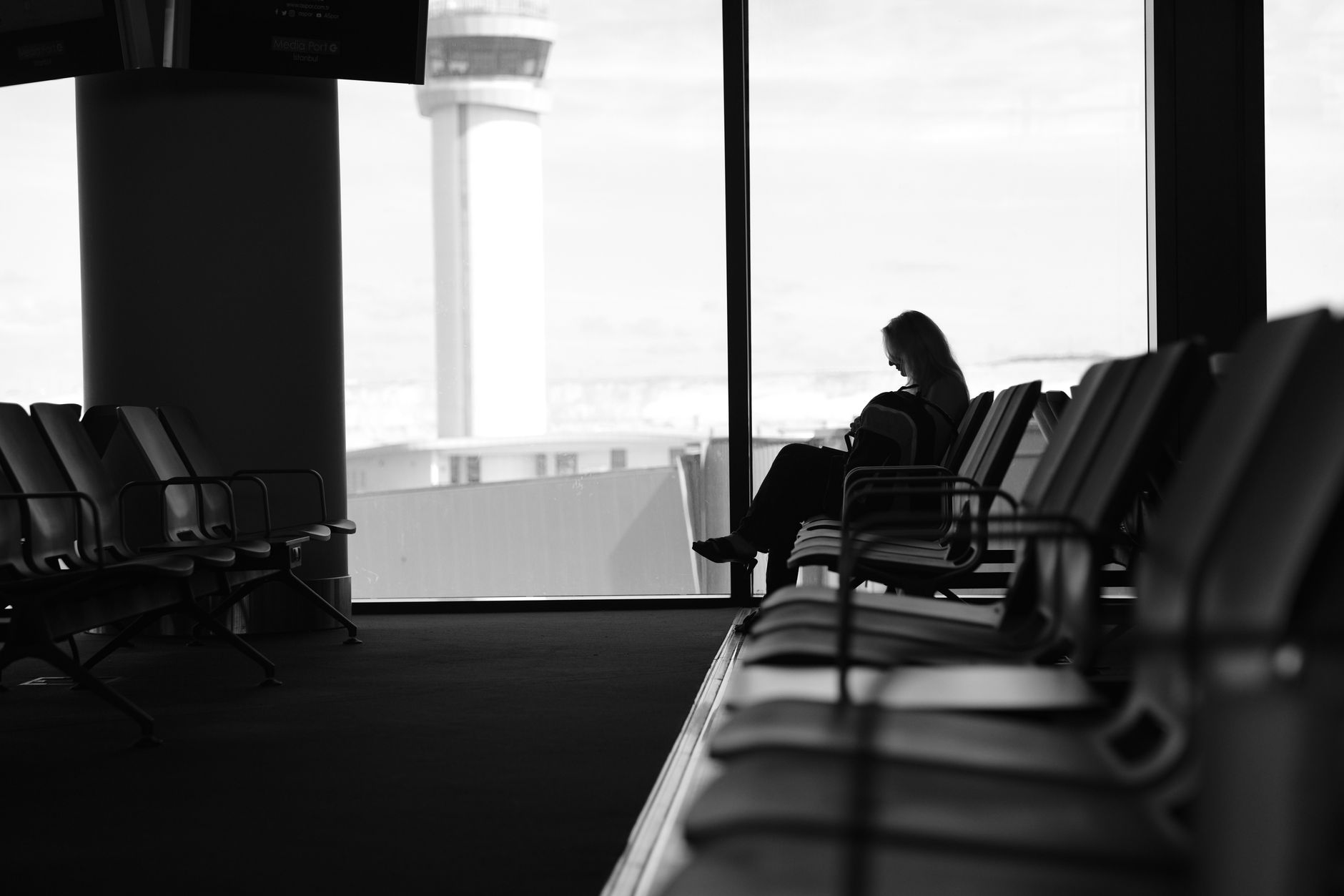 Contemporary airport lounge with comfortable seating, beverages, and modern interior design