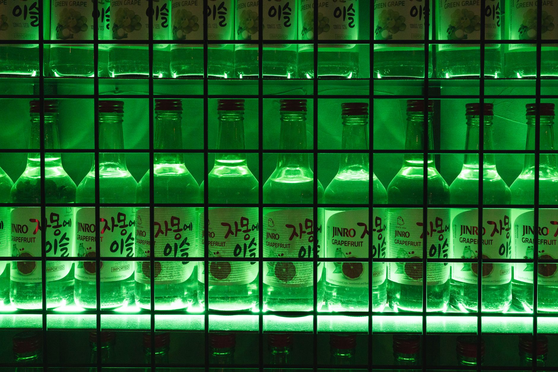 Three glasses of different Korean traditional alcoholic beverages including makgeolli, cheongju, and soju arranged for comparison
