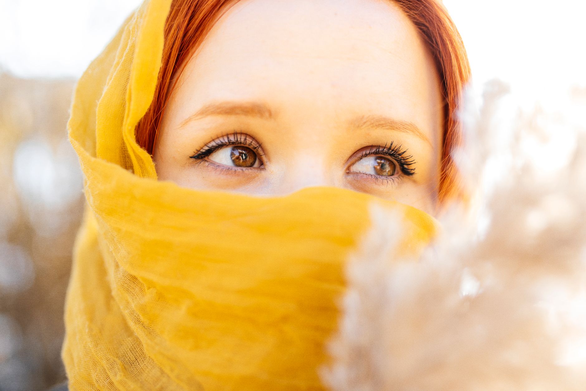 Woman with warm skin tone wearing colored contact lenses in hazel and honey shades, showcasing eye color change