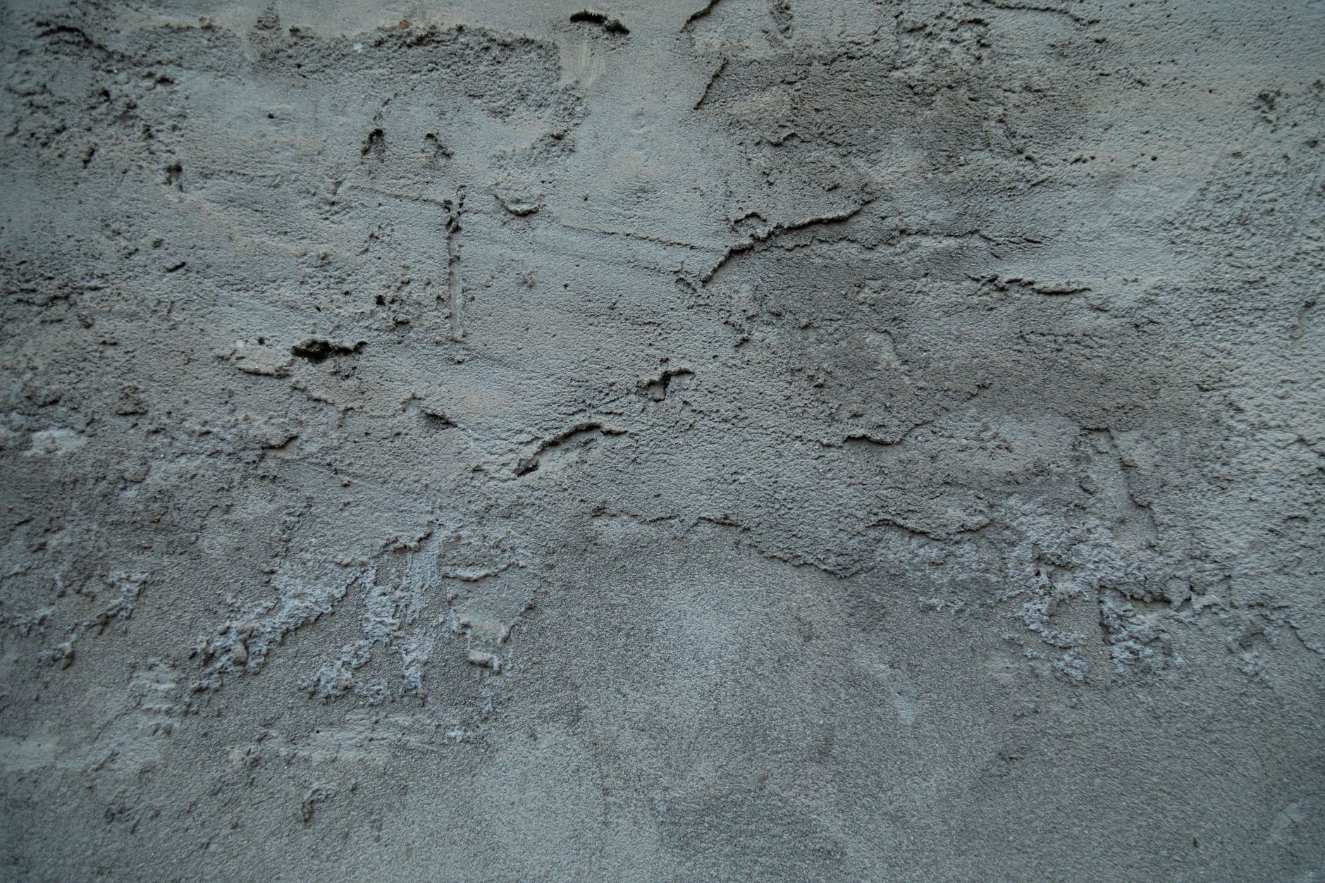 Close-up of foundation cracks in concrete wall showing damage patterns in residential home