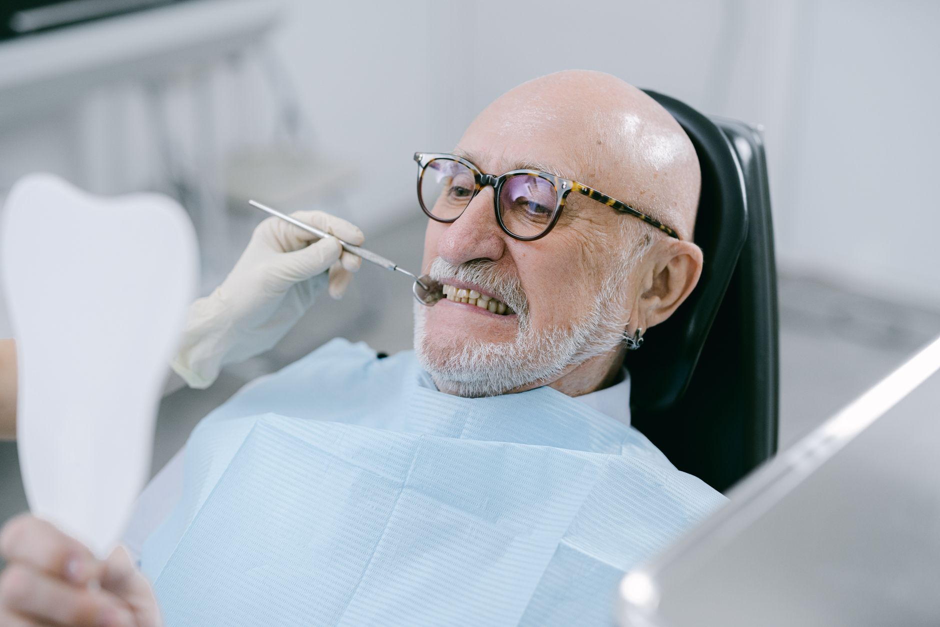 Elderly Korean woman receiving dental examination from healthcare provider in clinic