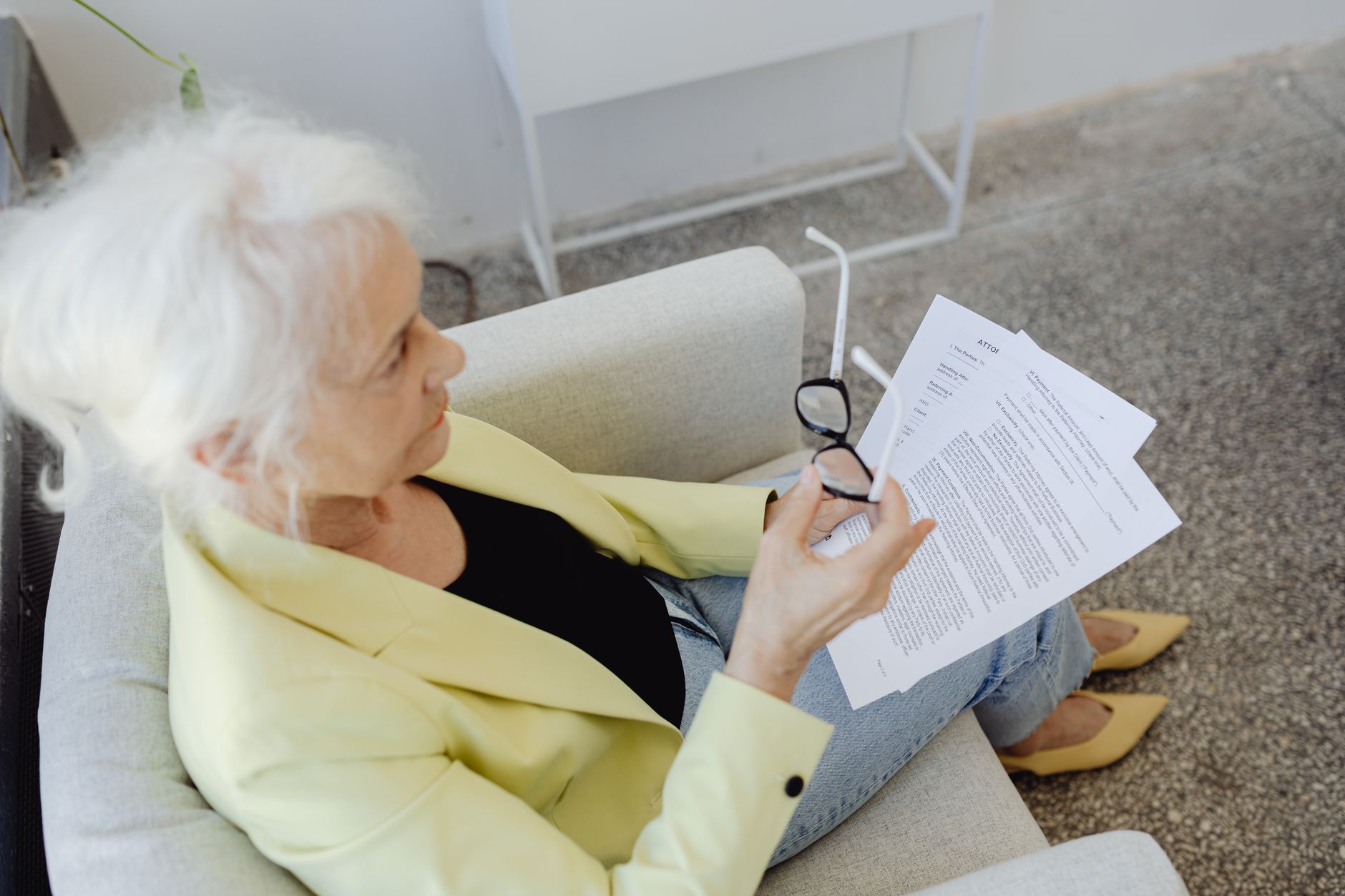 Mature Korean woman reviewing Medicare enrollment documents with healthcare advisor in office