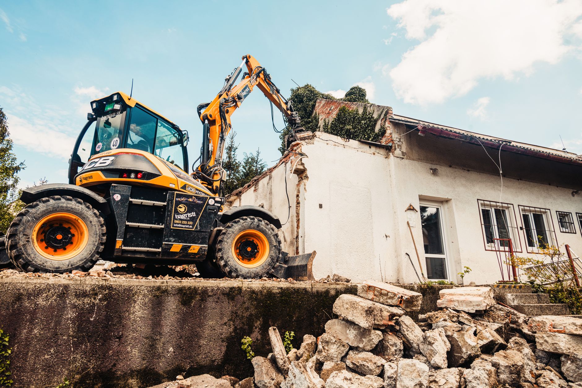 Professional demolition workers removing debris and rubble from a residential property demolition site