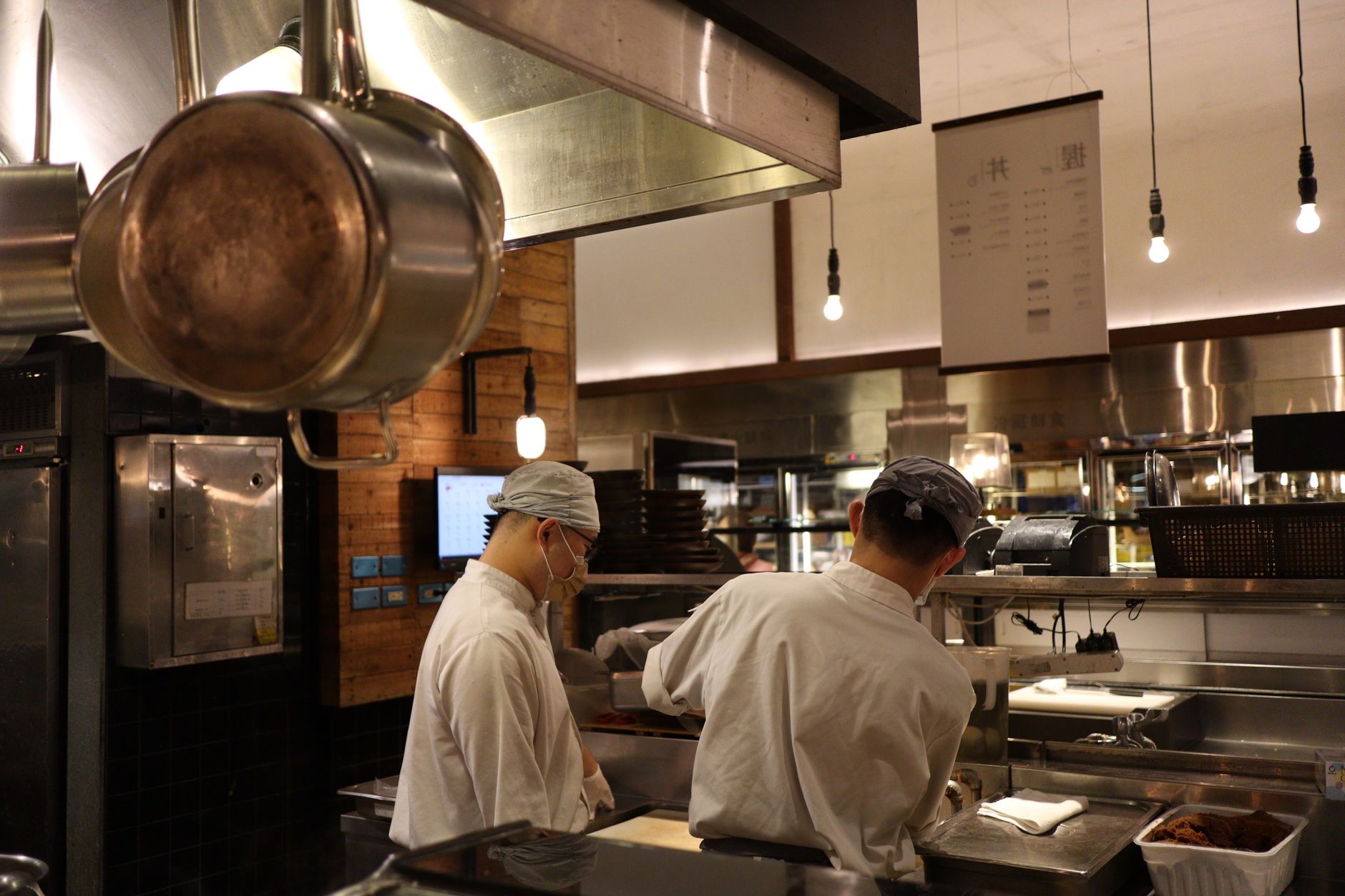 Two chefs working in a professional kitchen, highlighting culinary expertise and teamwork.