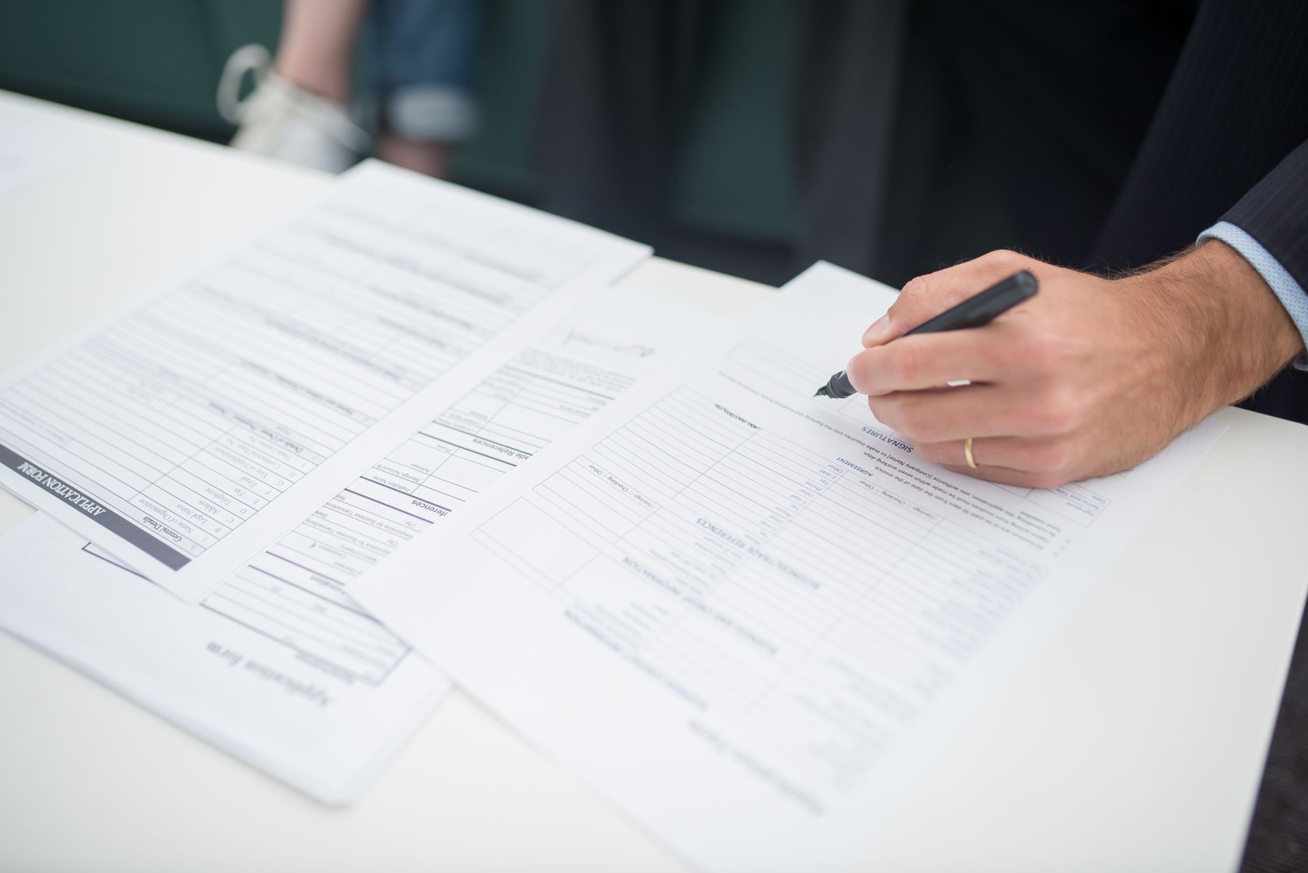 Close-up of insurance policy documents and contract papers with pen on desk