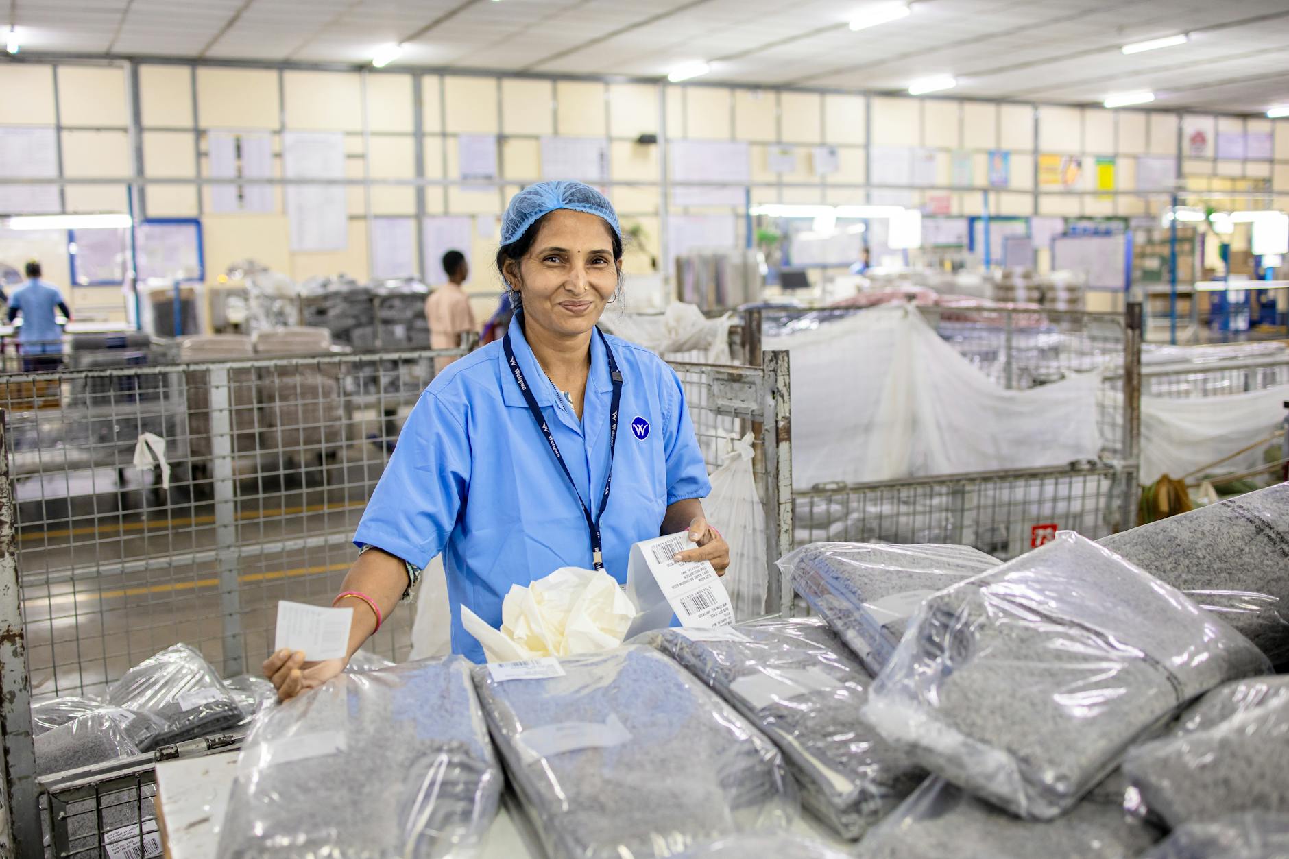 Diverse manufacturing team working together on production line in modern facility