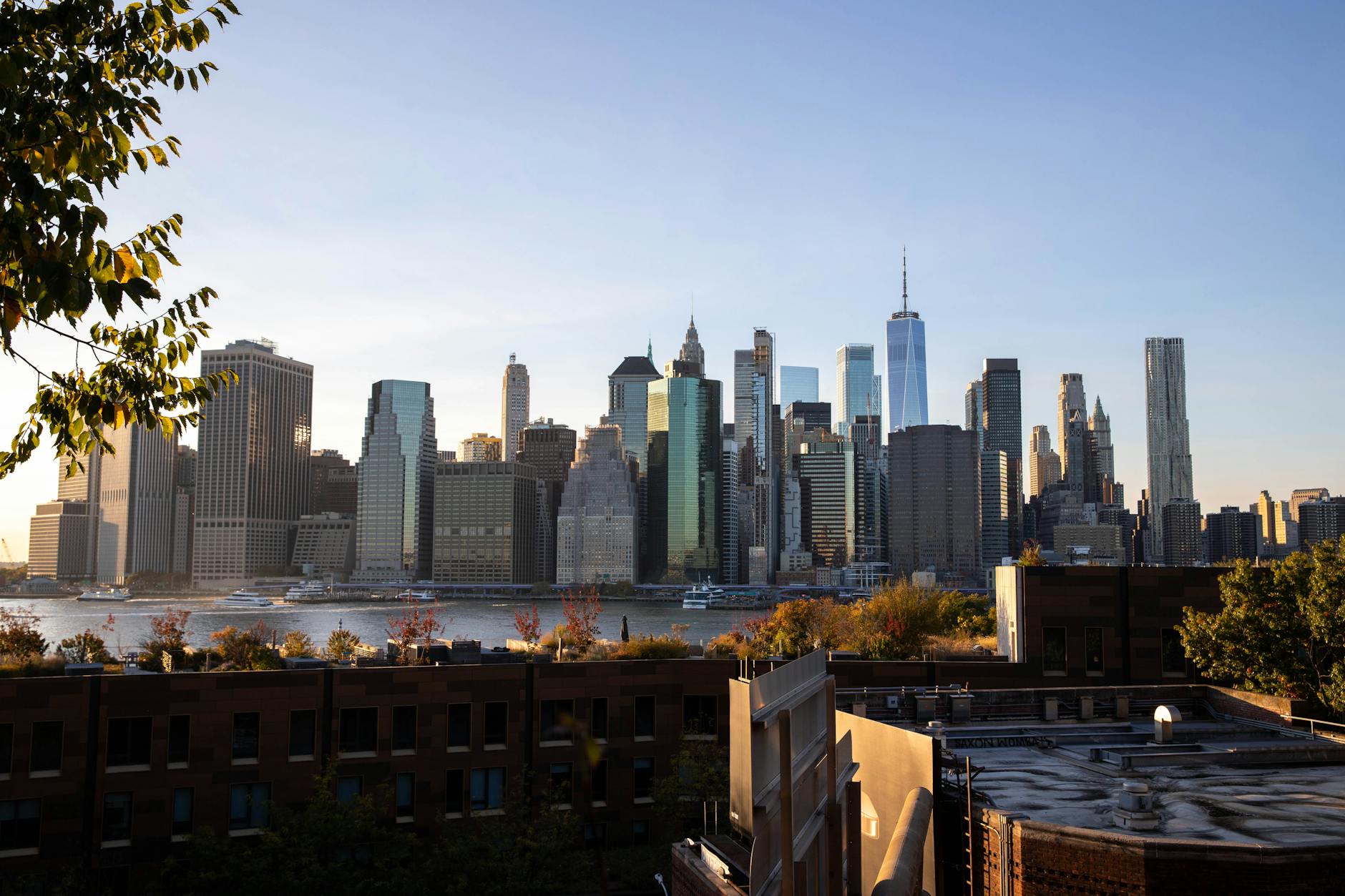 Luxury high-rise apartment building in Manhattan with city skyline view, representing prime real estate investment in New York