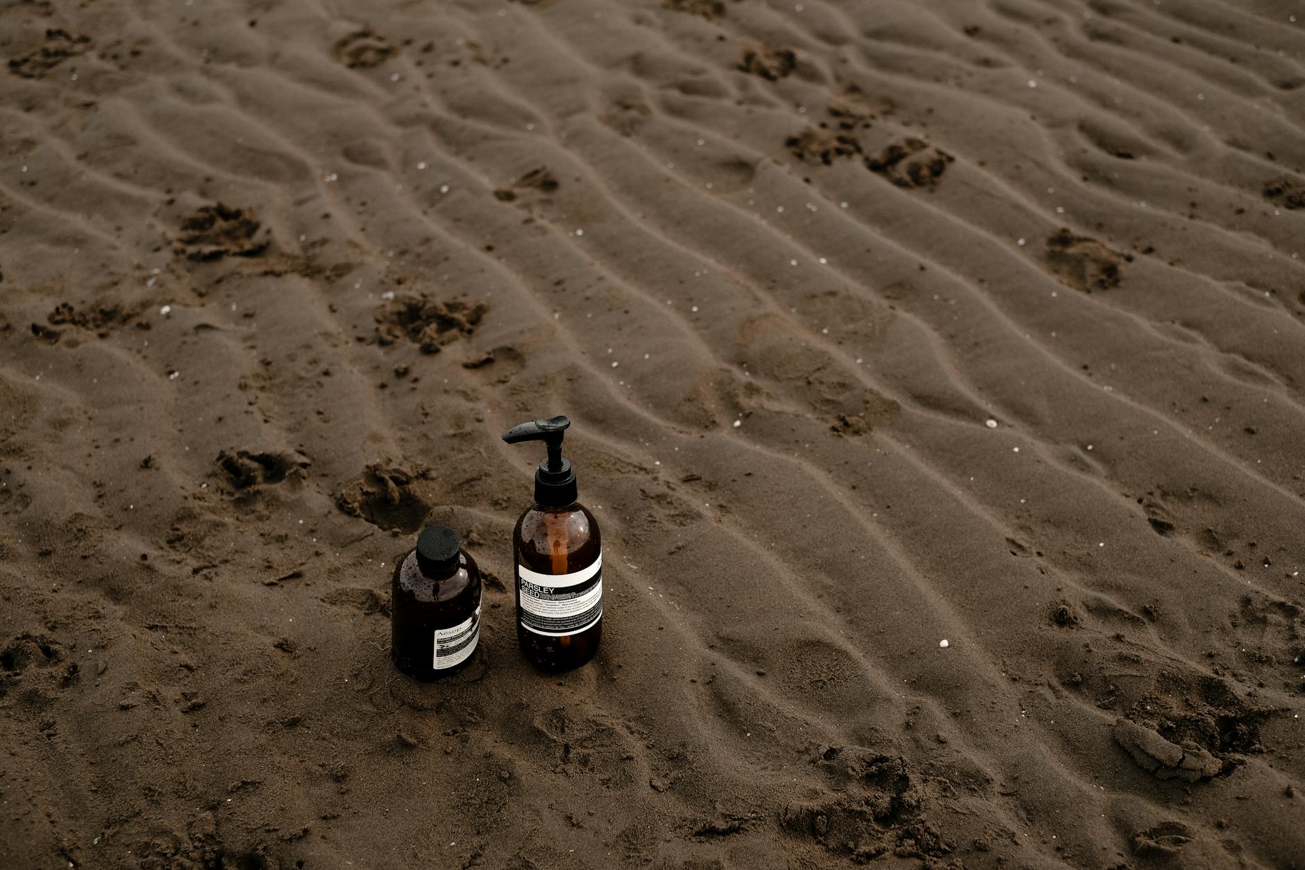 Non-toxic cleaning products with natural ingredients displayed on white surface, showing eco-friendly bottles and sustainable packaging