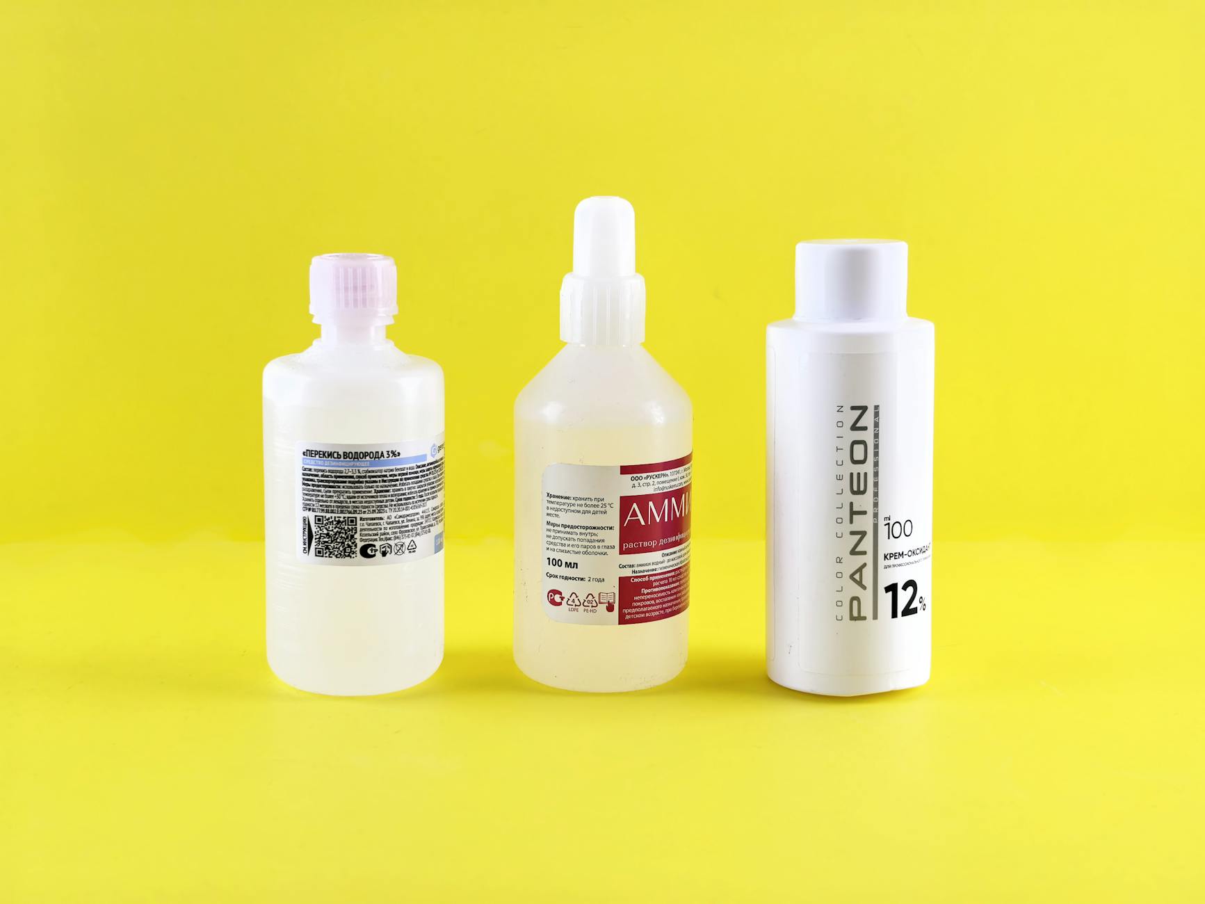 Plant-based cleaning product bottles with natural ingredients displayed on wooden surface