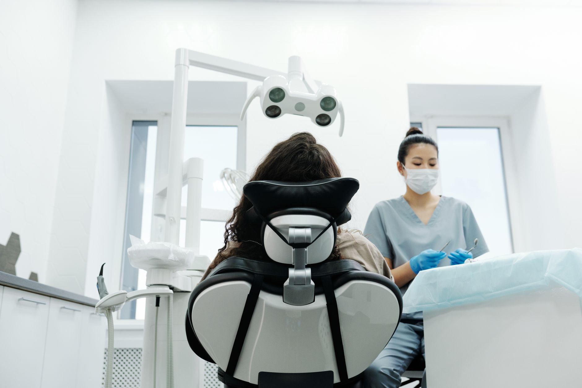Dentist performing dental implant procedure on patient in modern clinic setting