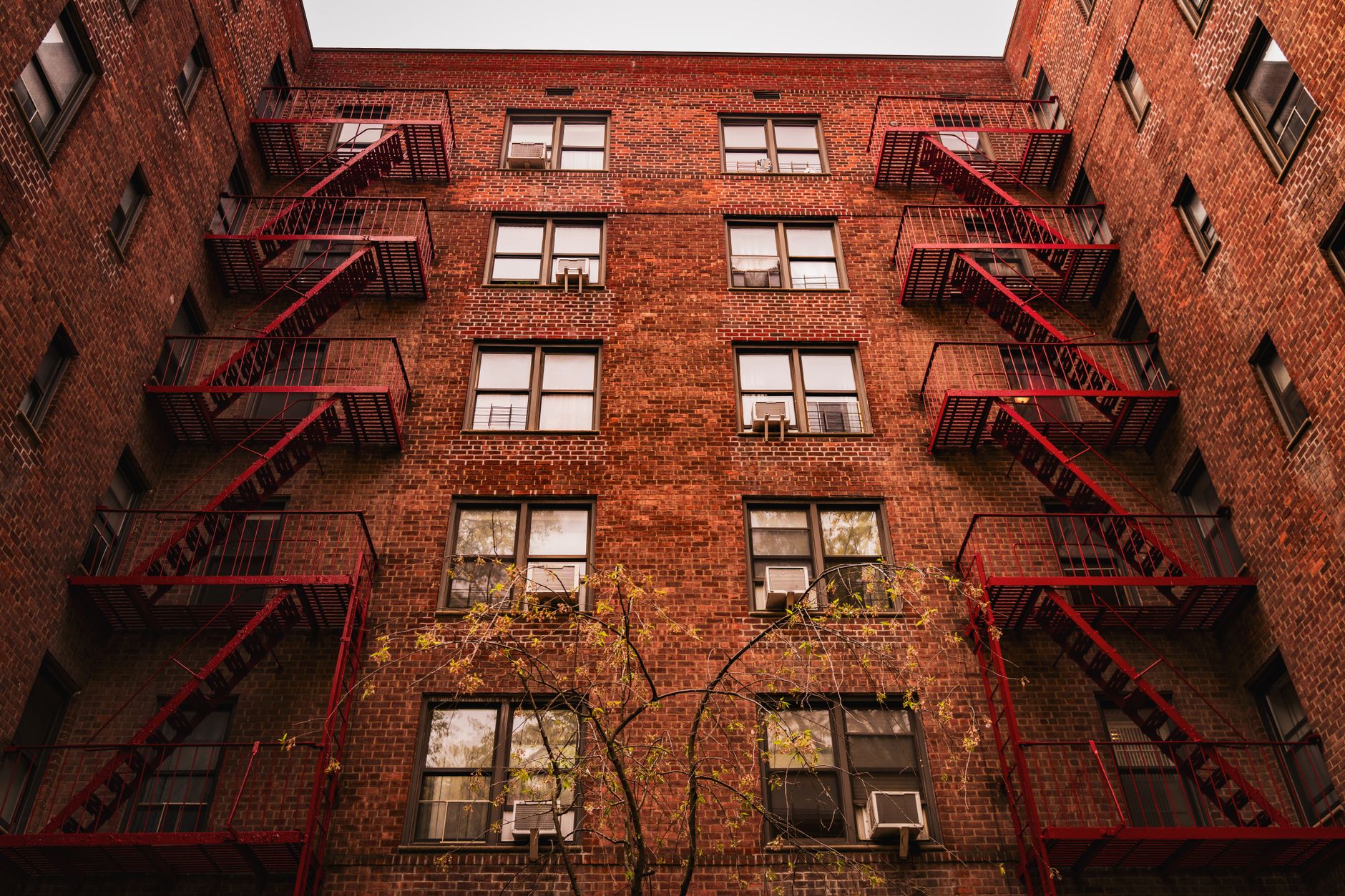 Modern multifamily residential building in NYC with street-level retail and mixed-use commercial space
