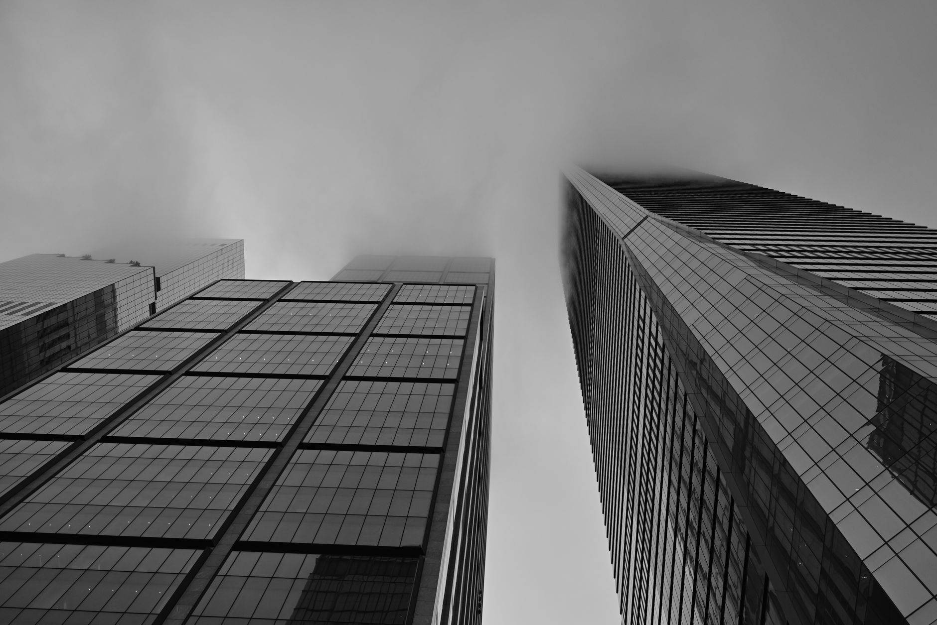 Modern commercial office building in New York City with glass facade and urban skyline