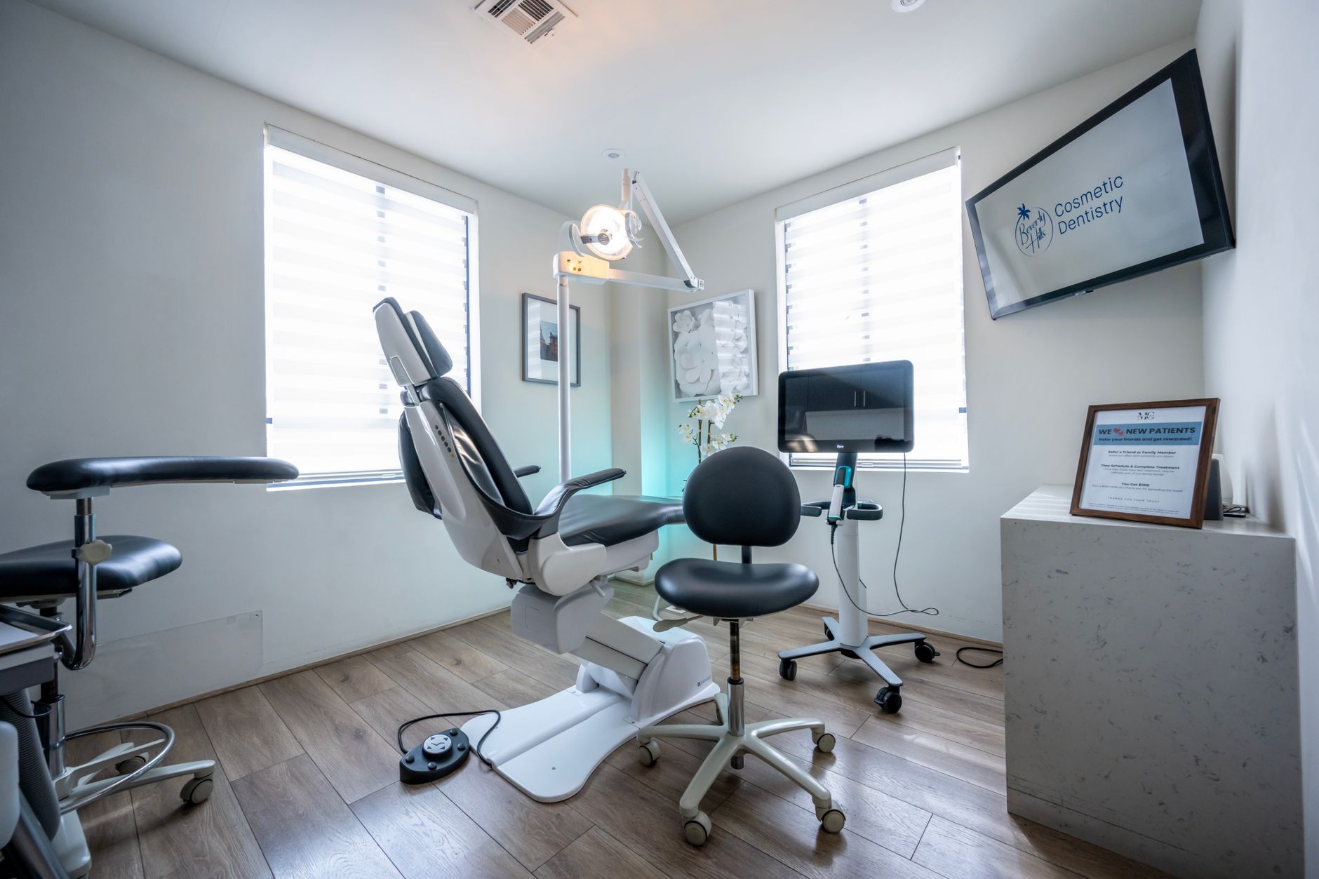 Professional cosmetic surgeon consulting with patient in modern medical office setting