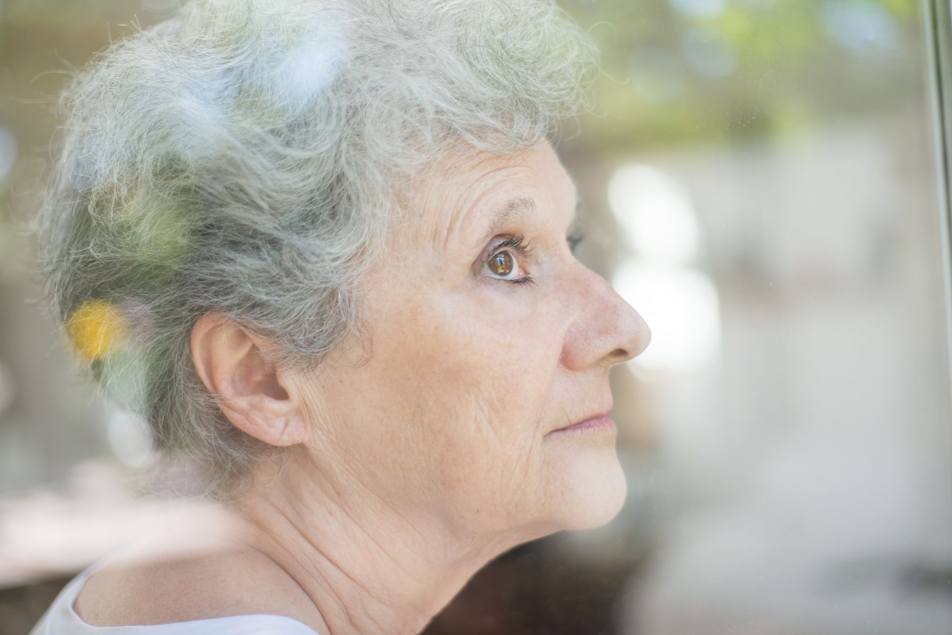Profile view of mature woman showing facial features and skin texture for cosmetic procedure comparison