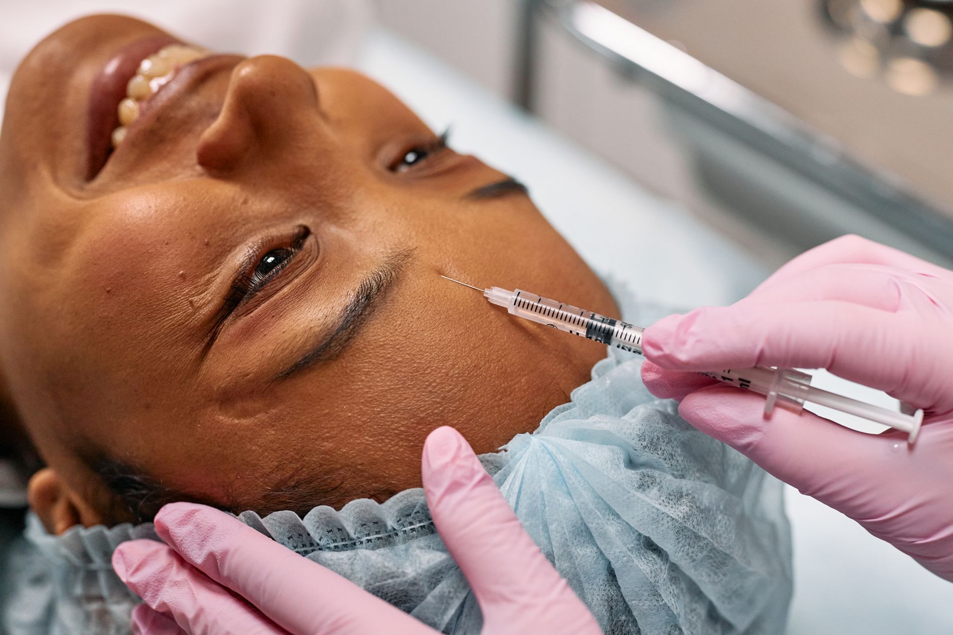 Close-up of botox injection being administered by a healthcare professional during cosmetic treatment