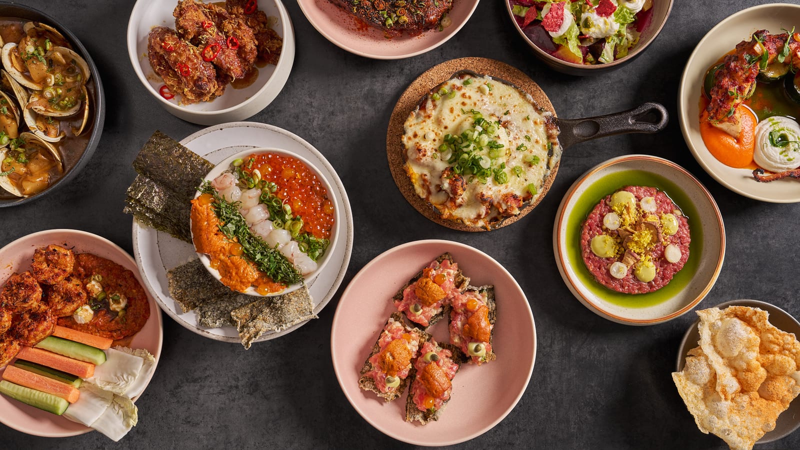 Overhead view of a full table of shared Korean dishes at 8282