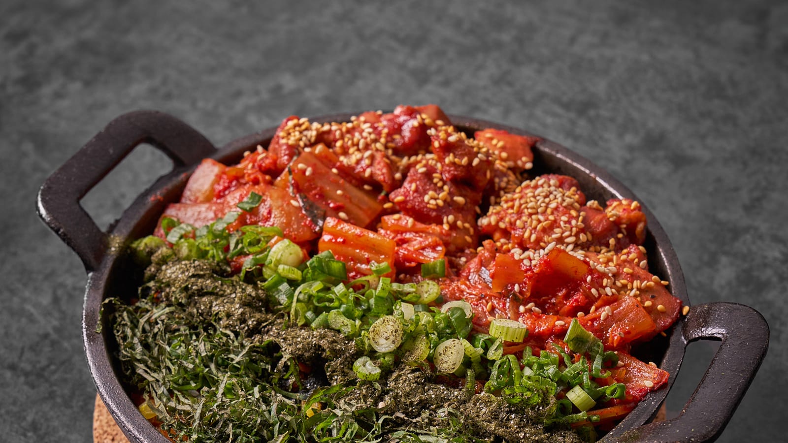 Kimchi rice skillet topped with roe, seaweed and scallions at 8282