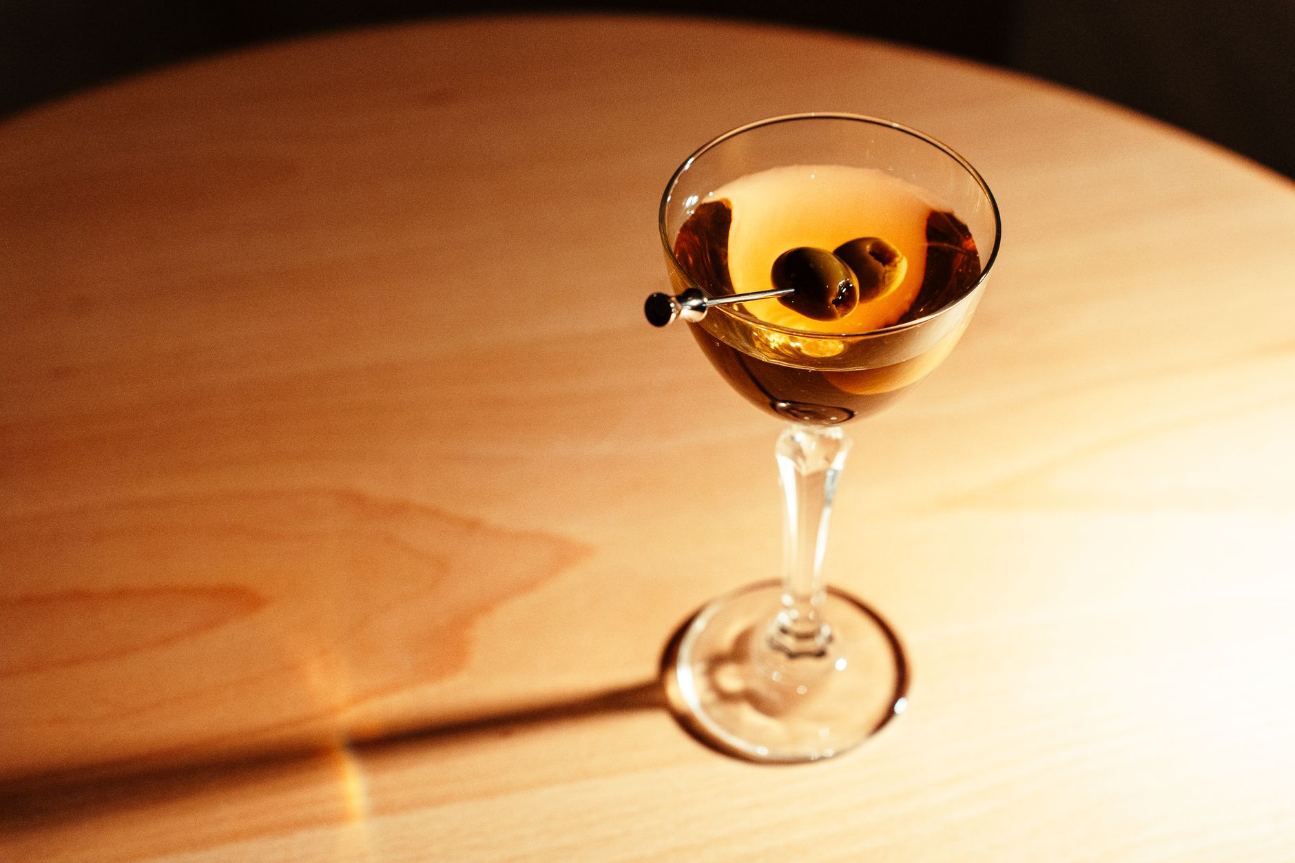 Sophisticated Korean-inspired cocktail served in a modern NYC restaurant with ambient lighting and elegant glassware