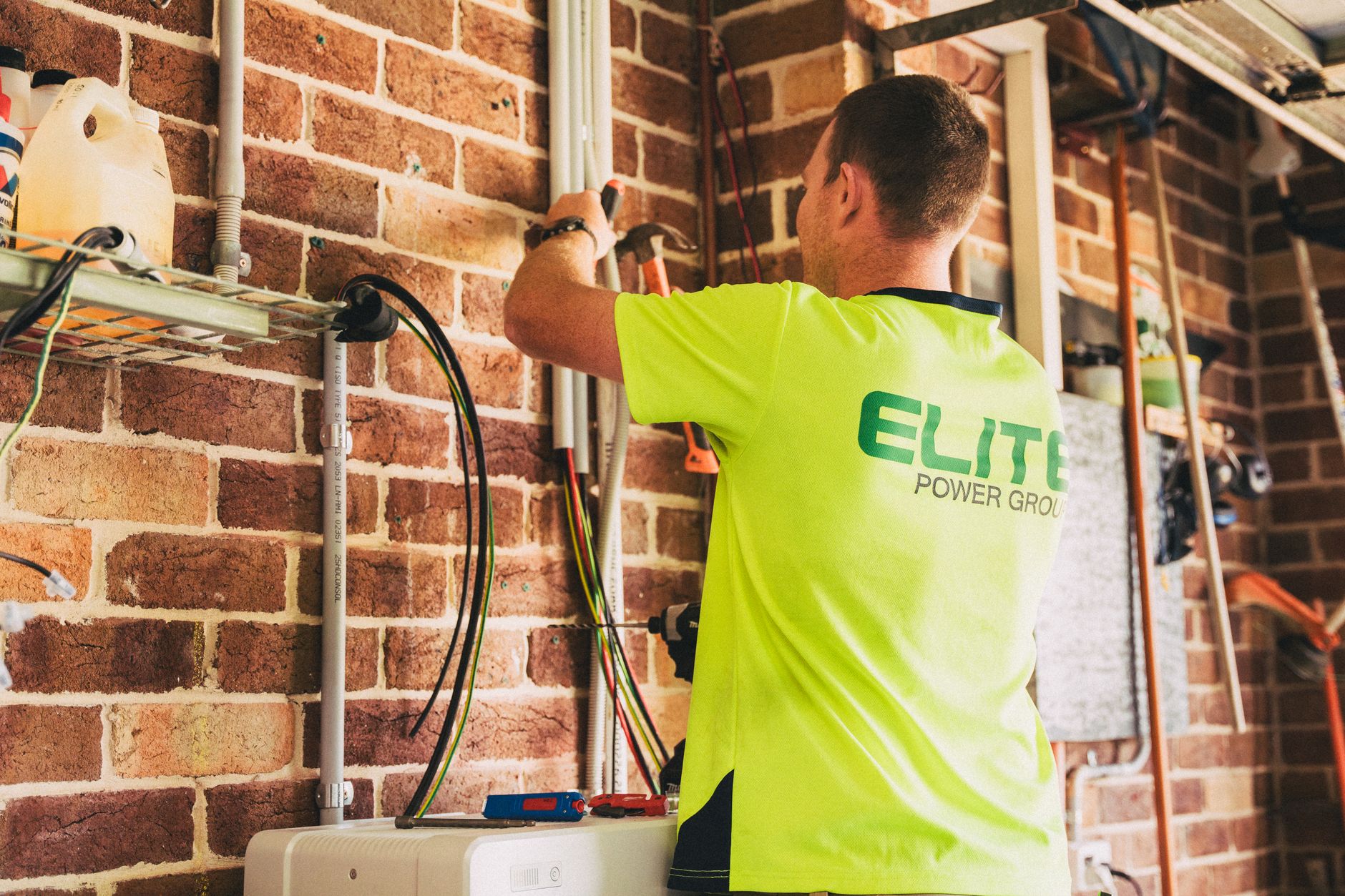 Professional electrician working on a 200-amp electrical panel installation in a residential home