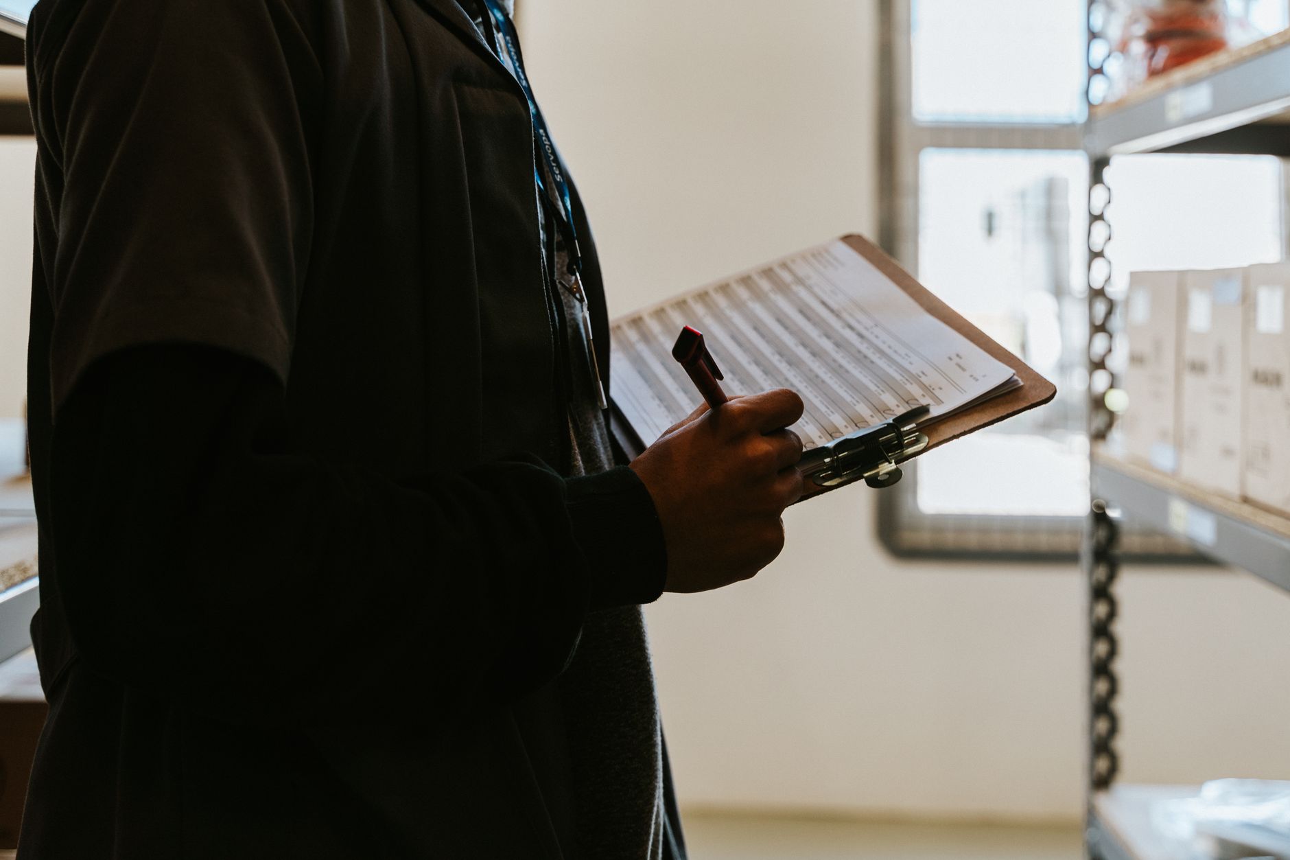 Professional electrician reviewing license documents and credentials on clipboard
